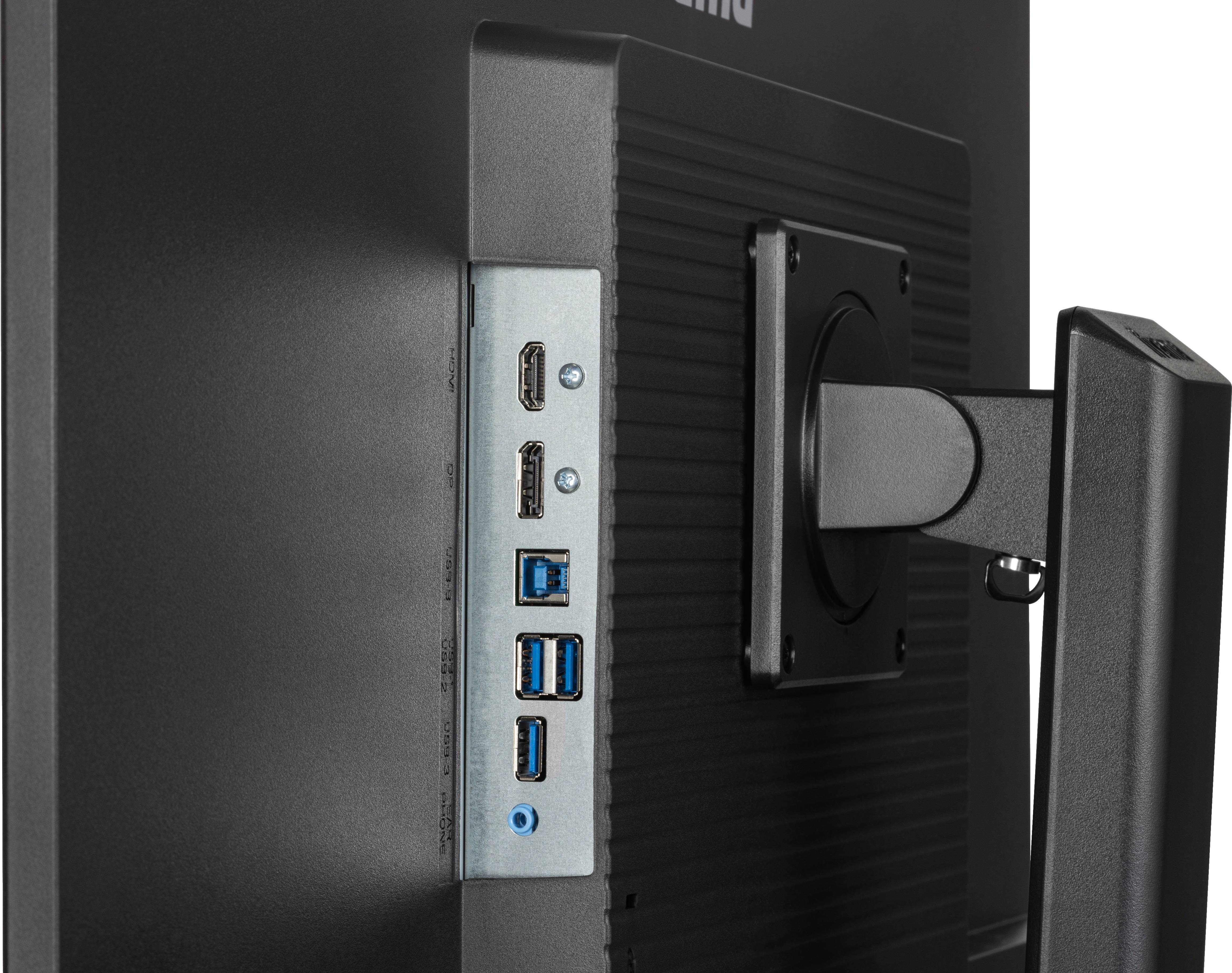 Pohled zezadu na monitor s několika porty, včetně HDMI a USB portů umístěných po straně.