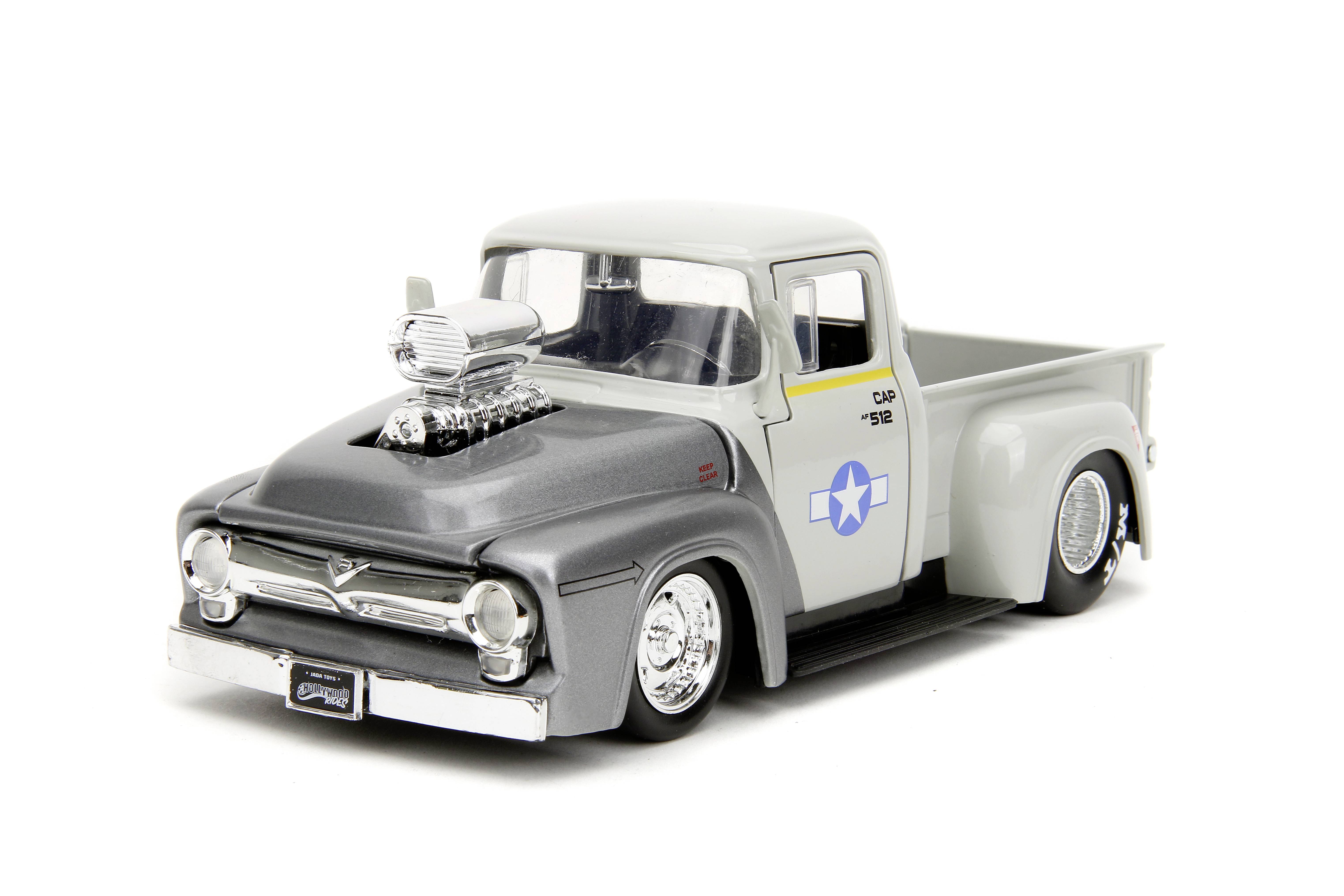 Šedé a bílé modelové auto veteránského pickupu s nadsazeným motorovým blokem na kapotě, stylizovaný americký letecký odznak na boku.