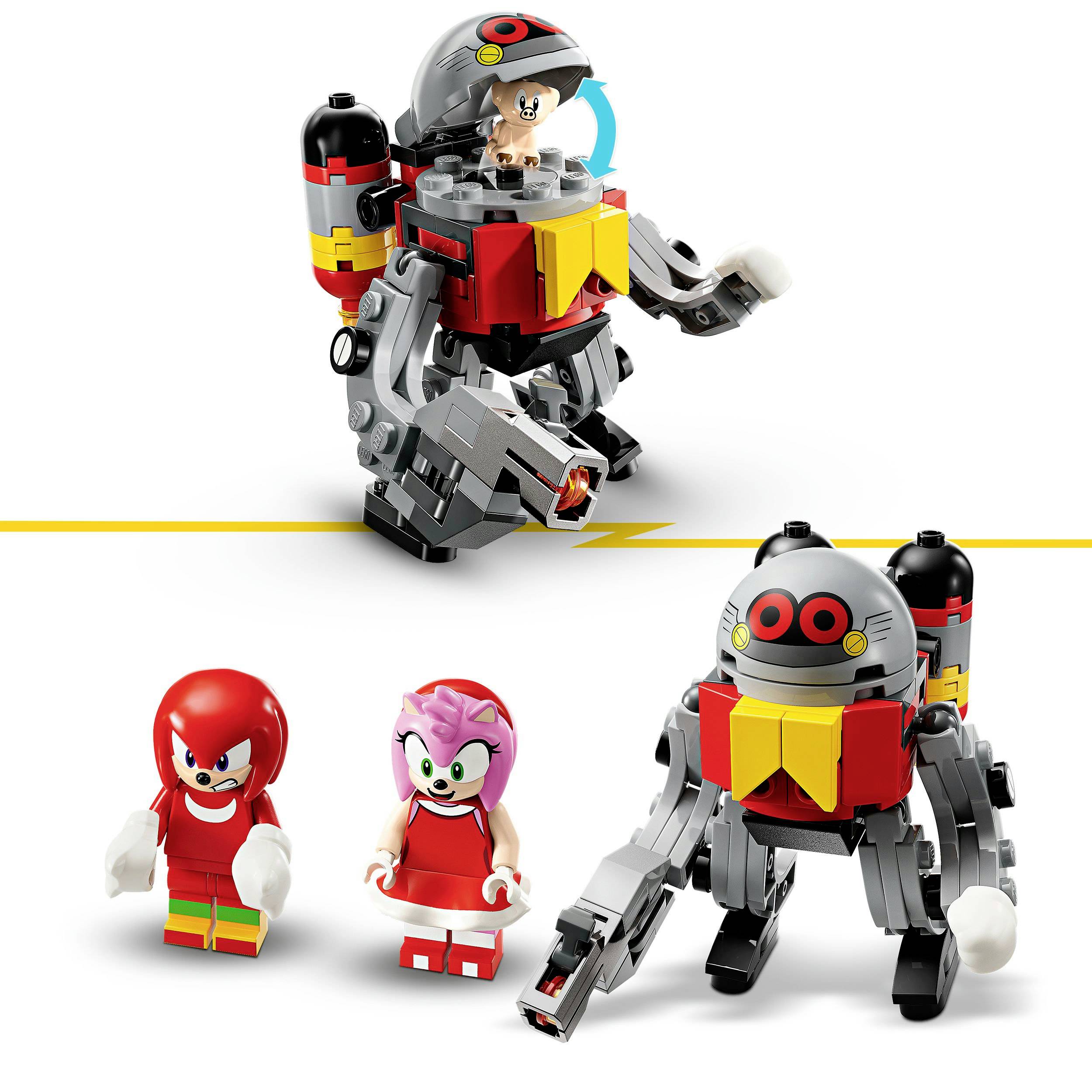 Hračkářský robot s malým prasátkem za volantem, vedle něj dvě postavičky v pestrých oblecích. Scéna je barevná a hravá.