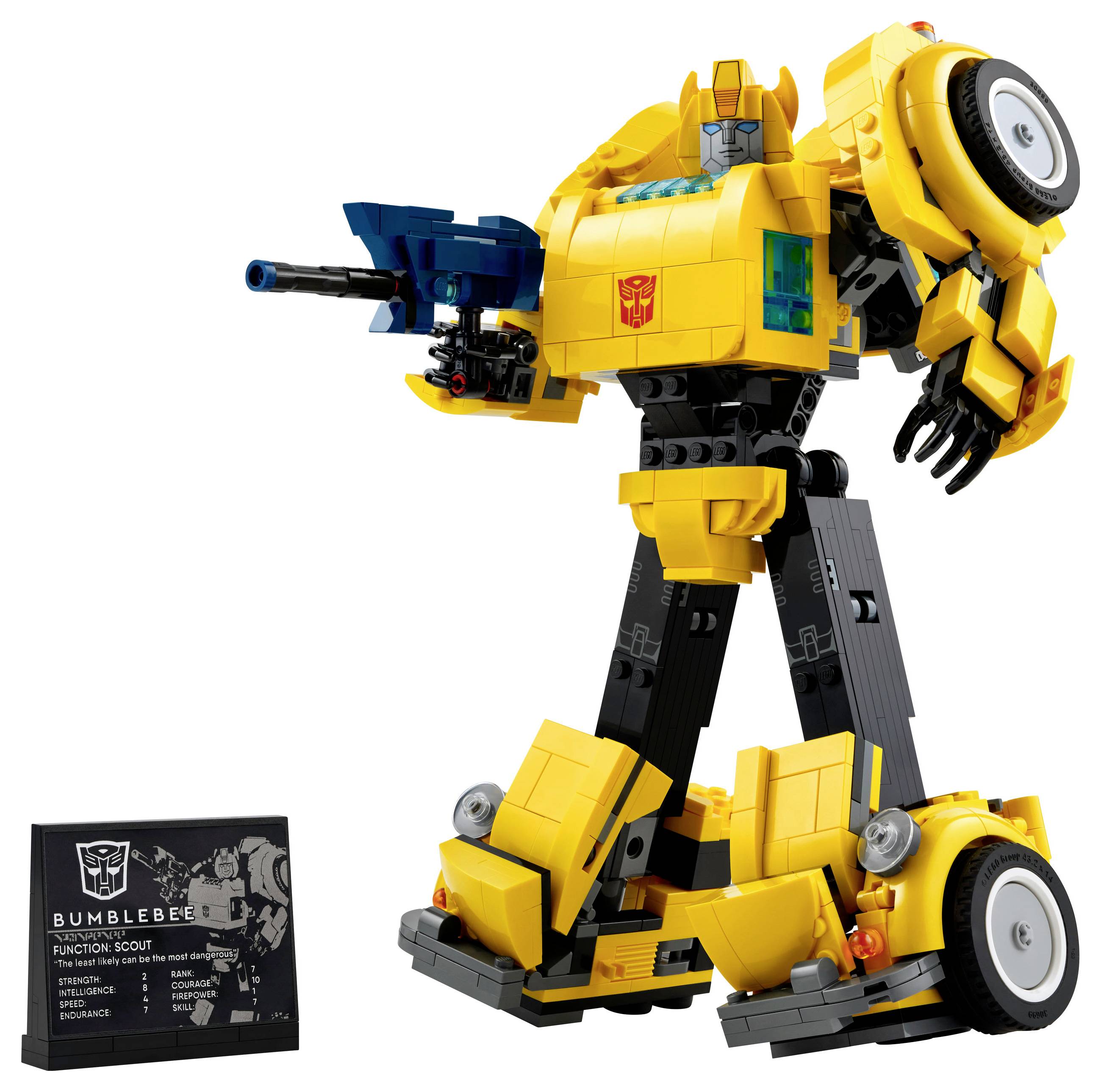 Velký žlutý robot s modrou kanónem na paži stojí na kolech. Vedle něj je cedule s informacemi.