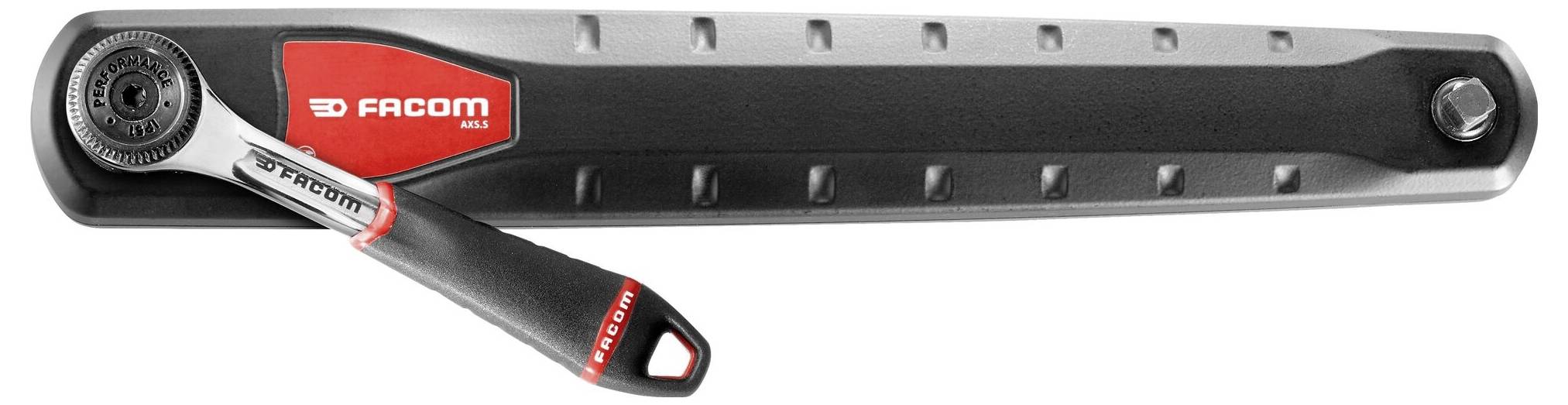 Dlouhá ráčna značky Facom s ergonomickou rukojetí a menším nástavcem pro nástrčné hlavice, vhodná pro mechanické práce.