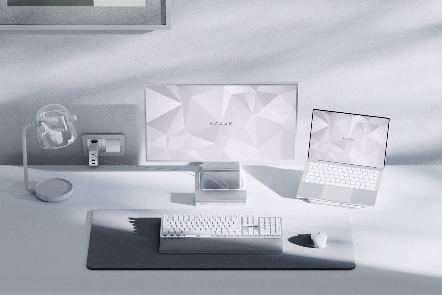 Minimalistické počítačové pracoviště s monitorem, laptopem, klávesnicí a myší v jednotném bílém designu.