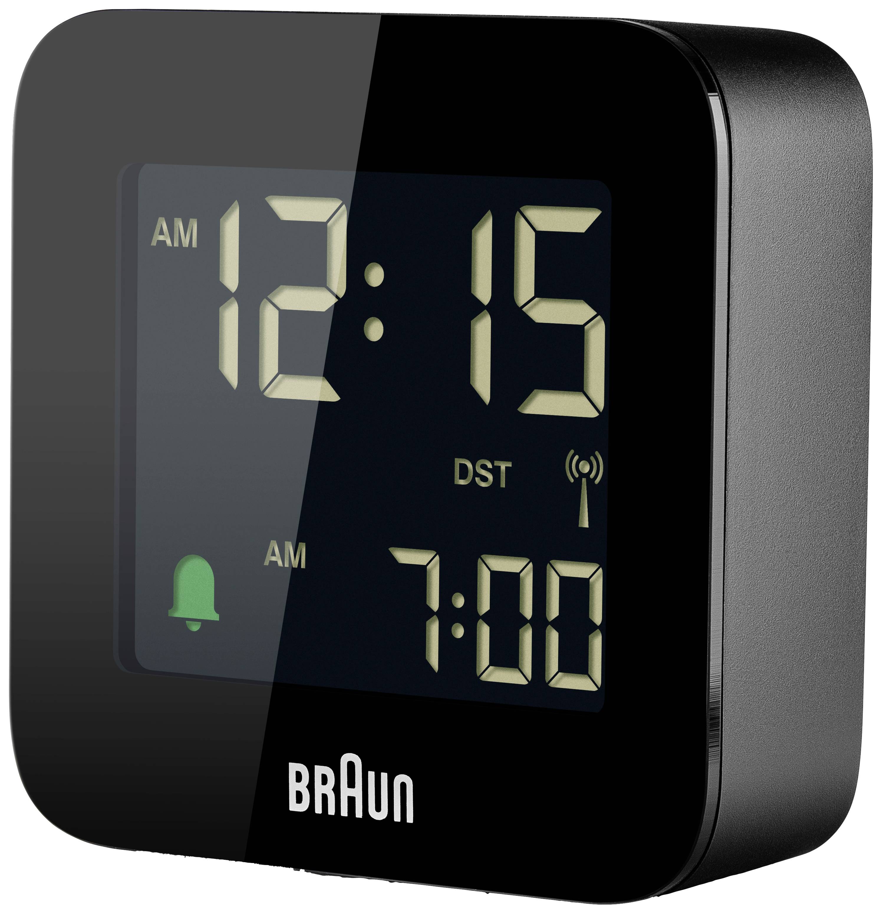 Černý digitální budík značky 'Braun' ukazuje '12:15' a aktivovaný alarm s nastaveným časem buzení '7:00'.