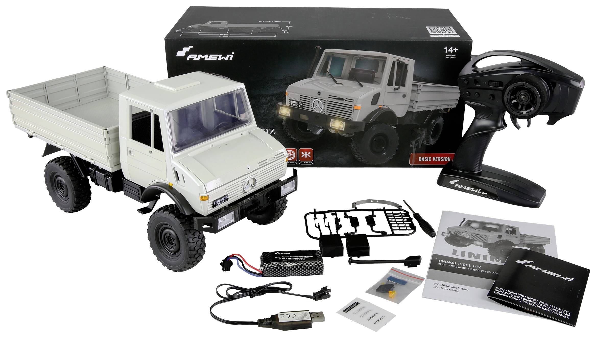 Dálkově ovládaný model šedého nákladního vozu s příslušenstvím, jako jsou dálkový ovladač, baterie a kabely, zobrazený před obalem.