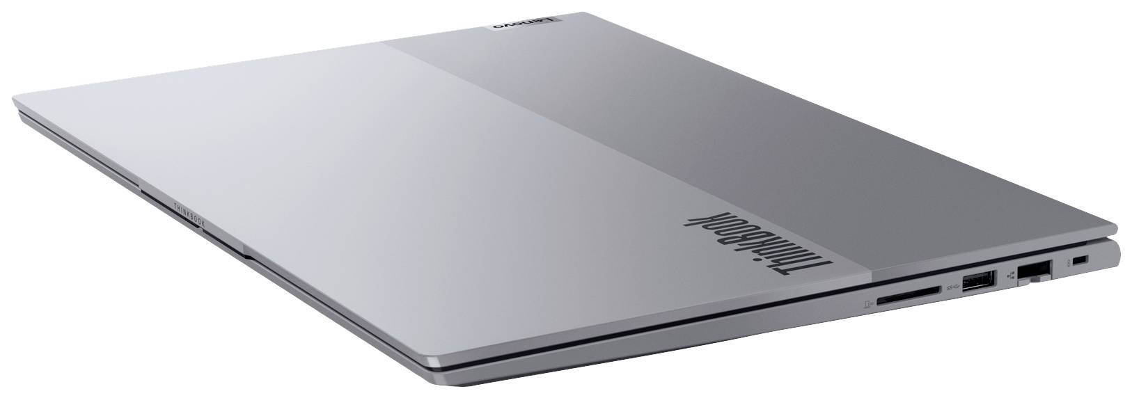 Šedý uzavřený notebook, pohledem z boku, vykazuje jemně zaoblené hrany a několik připojovacích portů.