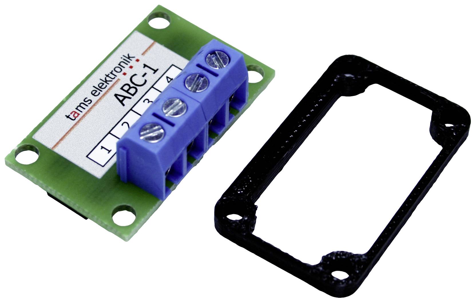 Zelený elektronický modul s modrým svorkovým blokem s nápisem 'tams elektronik ABC-1'. Vpravo vedle něj černý držák.
