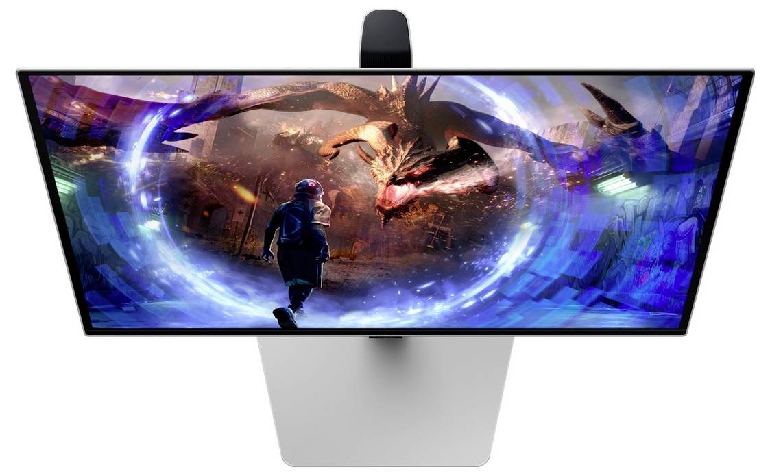 Monitor zobrazuje barevnou herní scénu, kde postava čelí ohnivému drakovi v futuristickém prostředí.