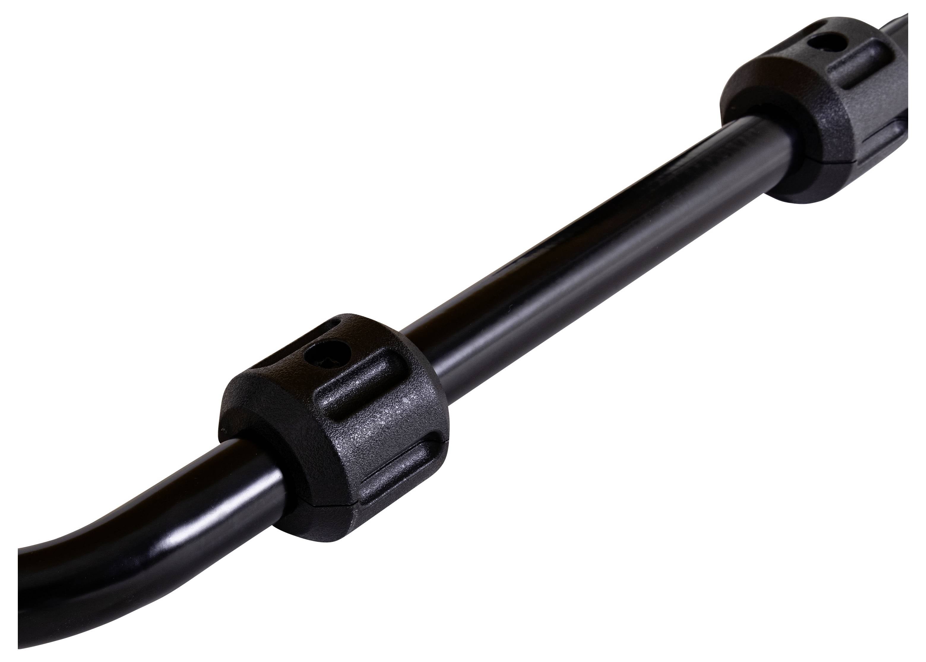 Černá tyč se dvěma kulatými, hrubě strukturovanými plastovými koncovkami.