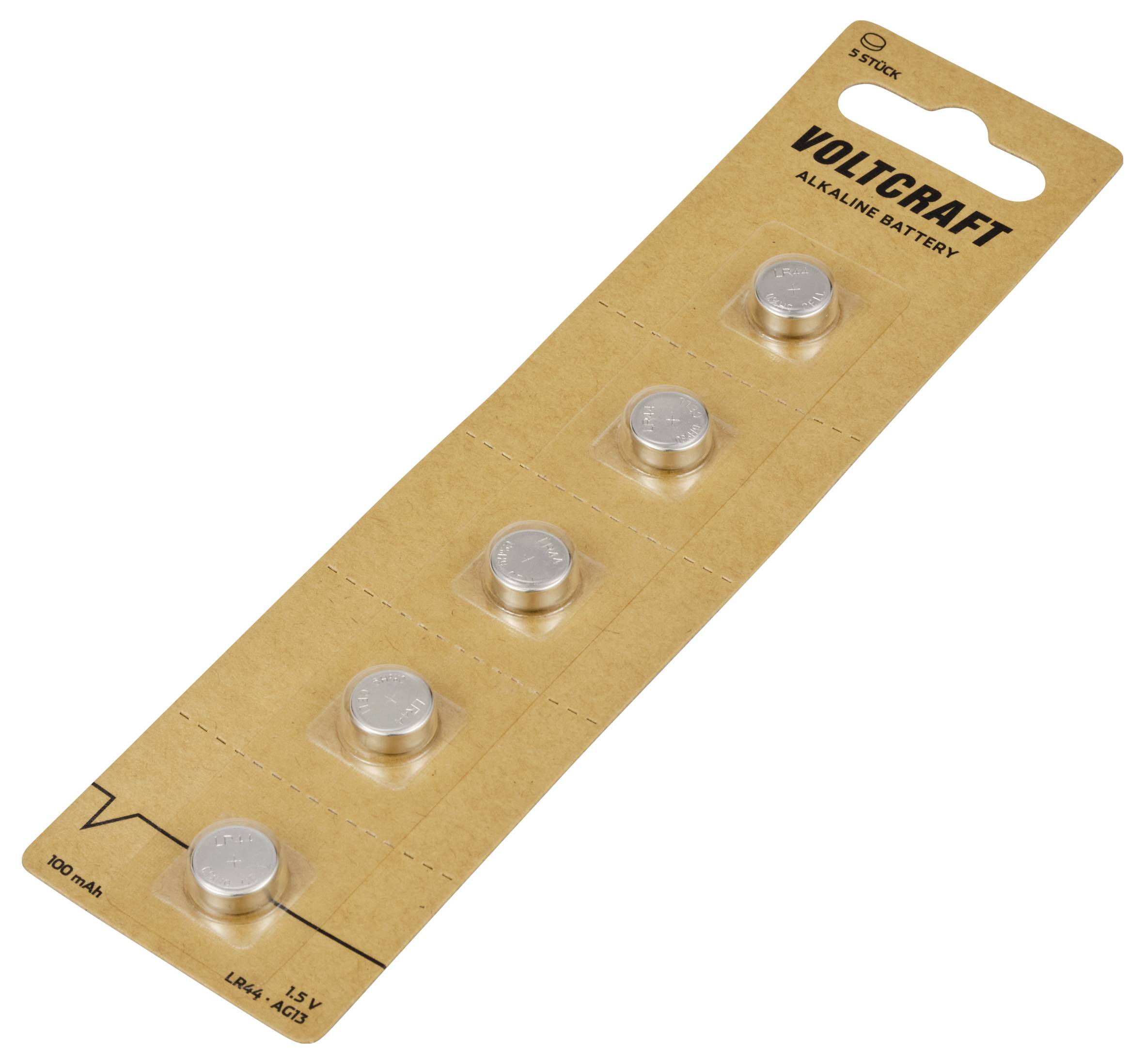 Pět knoflíkových baterií na hnědém papírovém proužku s nápisem 'VOLTCRAFT Alkaline Battery'.