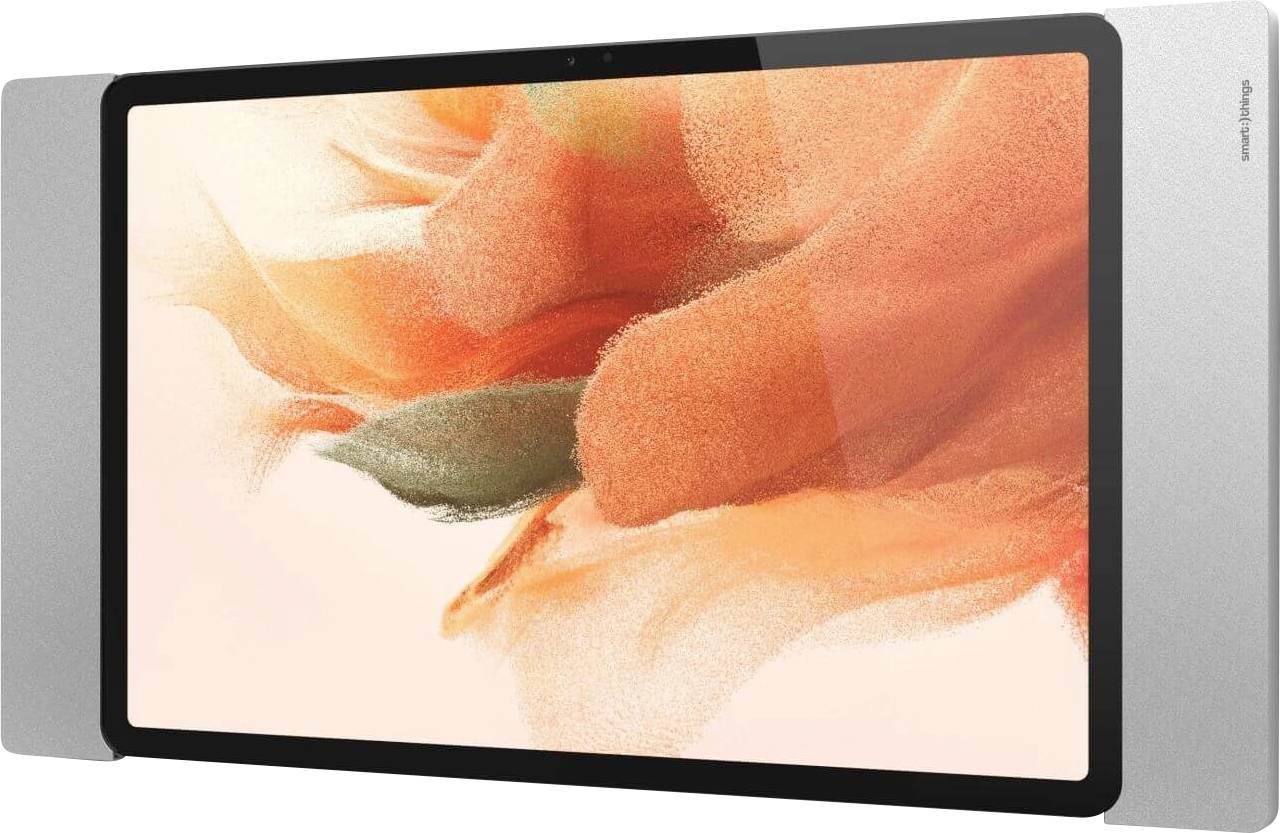 Tablet se stříbrným okrajem a displejem zobrazujícím abstraktní designový motiv květiny v oranžové barvě.