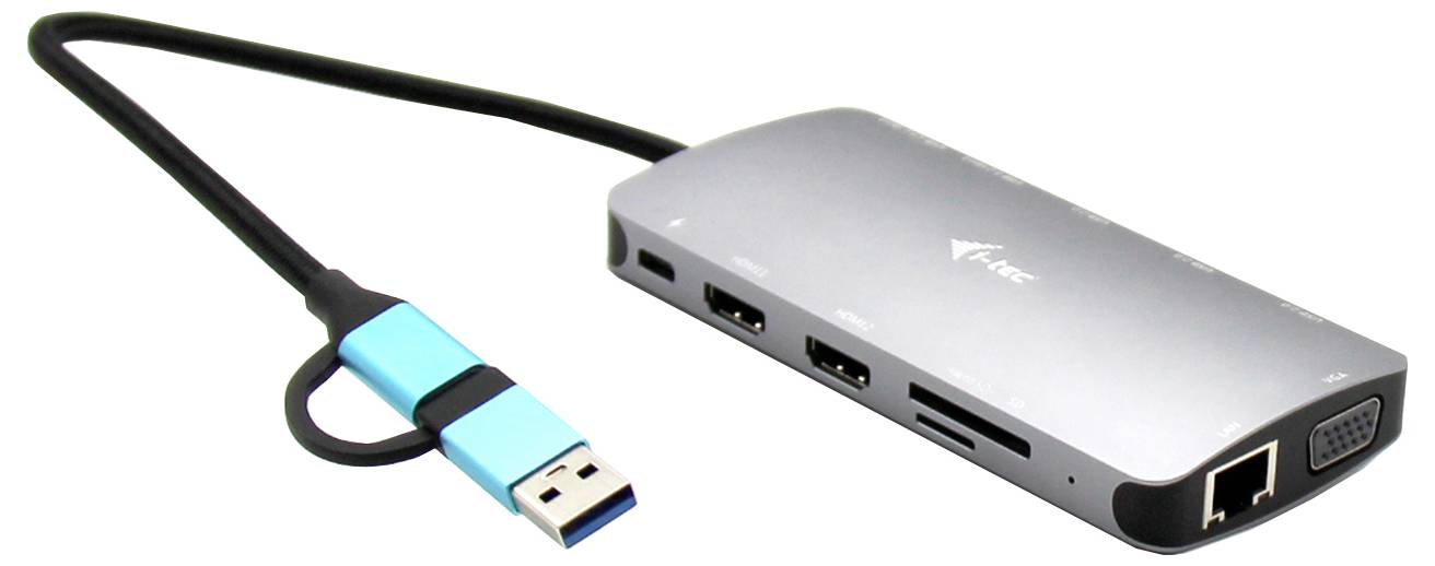 Externí adaptér ve stříbrné barvě s několika porty: USB, Ethernet, VGA a čtečka paměťových karet. Připojený přes modré USB kabel.