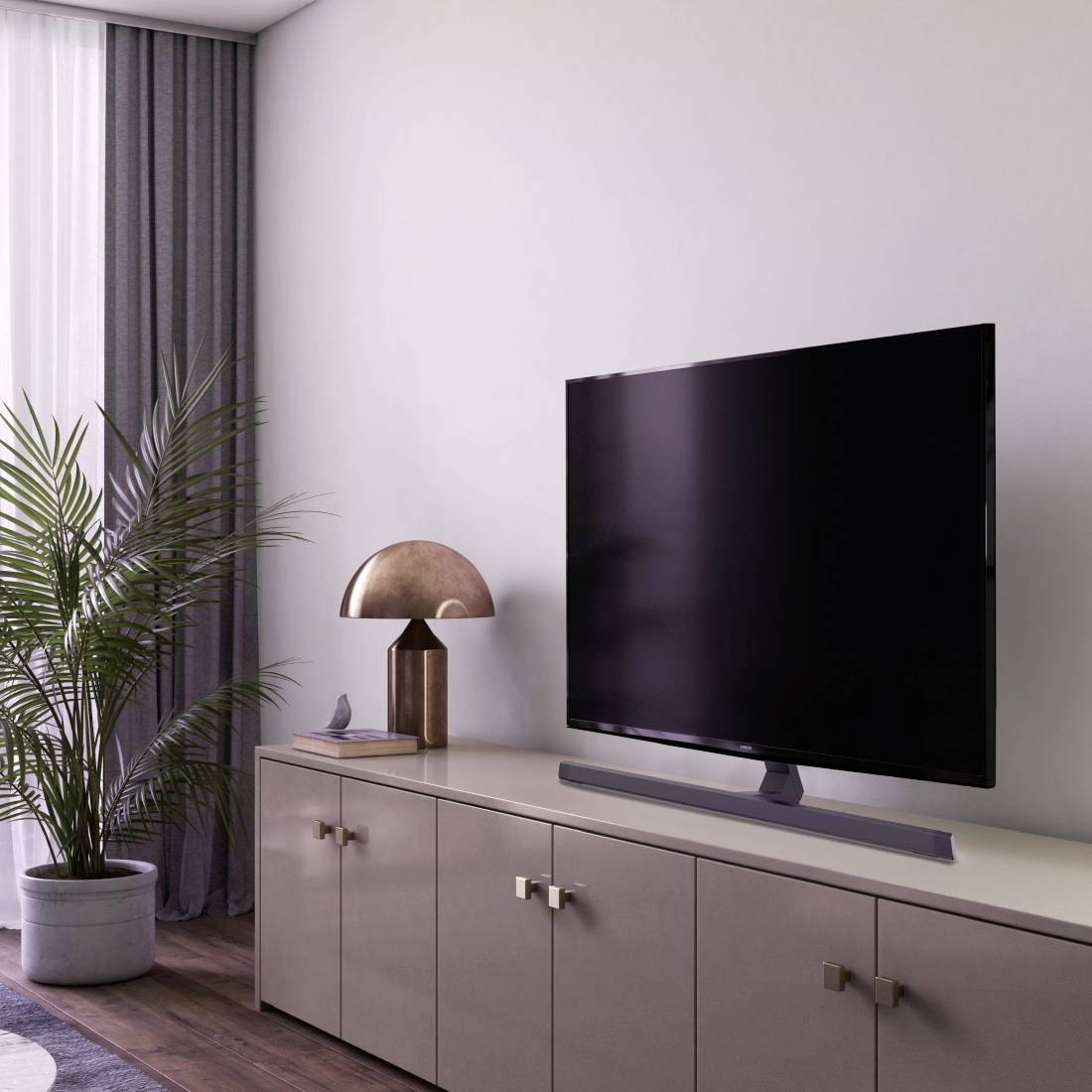 Moderní obývací pokoj s plochým televizorem na minimalistické skříňce, vedle které stojí pokojová rostlina a lampa.