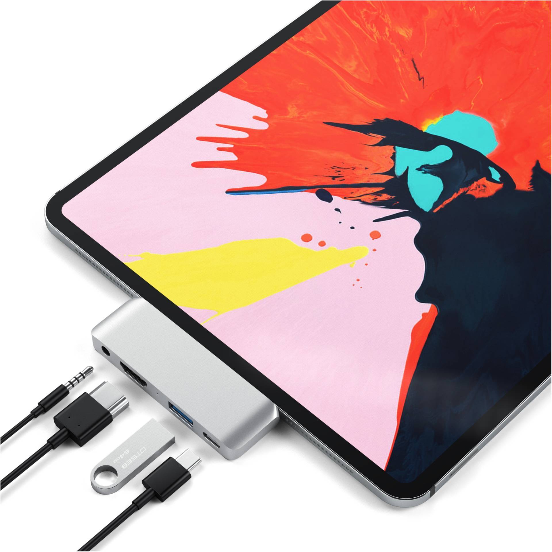 Tablet s dynamickým, barevným uměleckým dílem na obrazovce je připojeno k stříbrnému USB-C rozbočovači s několika porty.