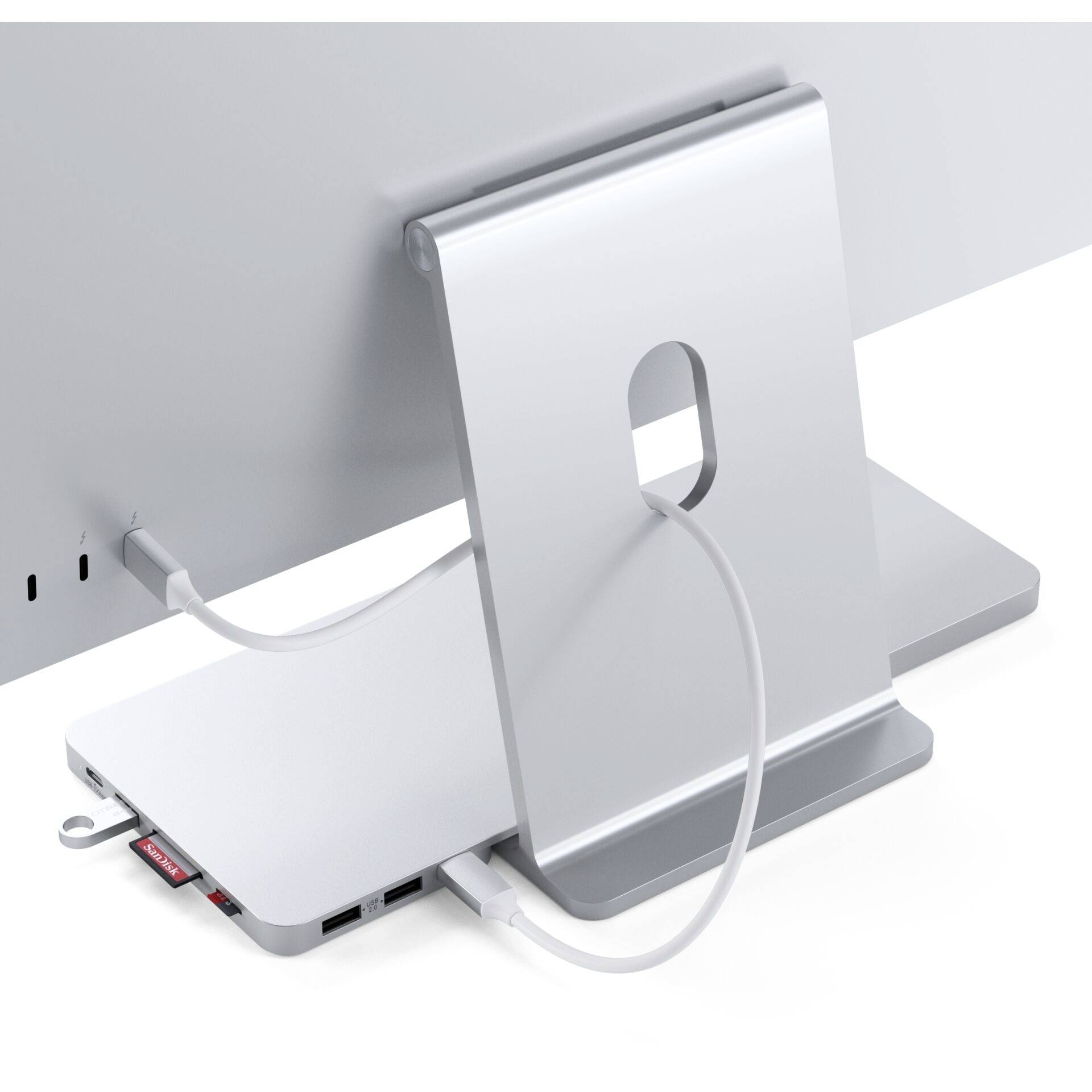 Stojan na monitor s integrovaným USB rozbočovačem. Má několik portů a je připojen k počítači.