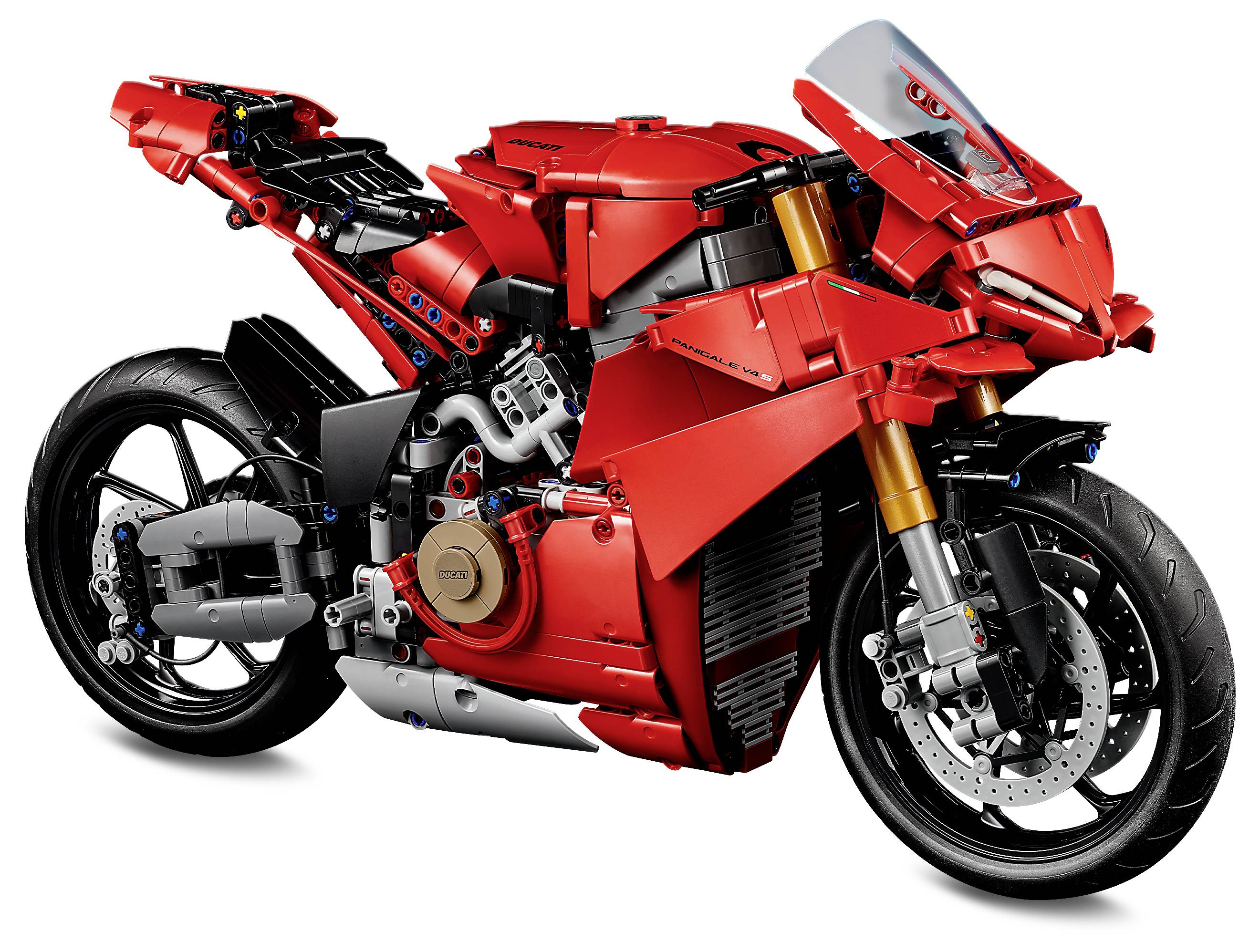 Červený, detailní model sportovní motorky s výraznými předními a zadními koly, výfukovými trubkami a realistickými kapotážemi.