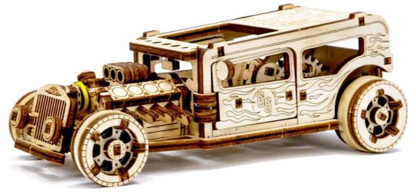 Dřevěný model klasického automobilového designu s detailní mechanikou a ozdobami, viditelná ozubená kola a pístový motor.