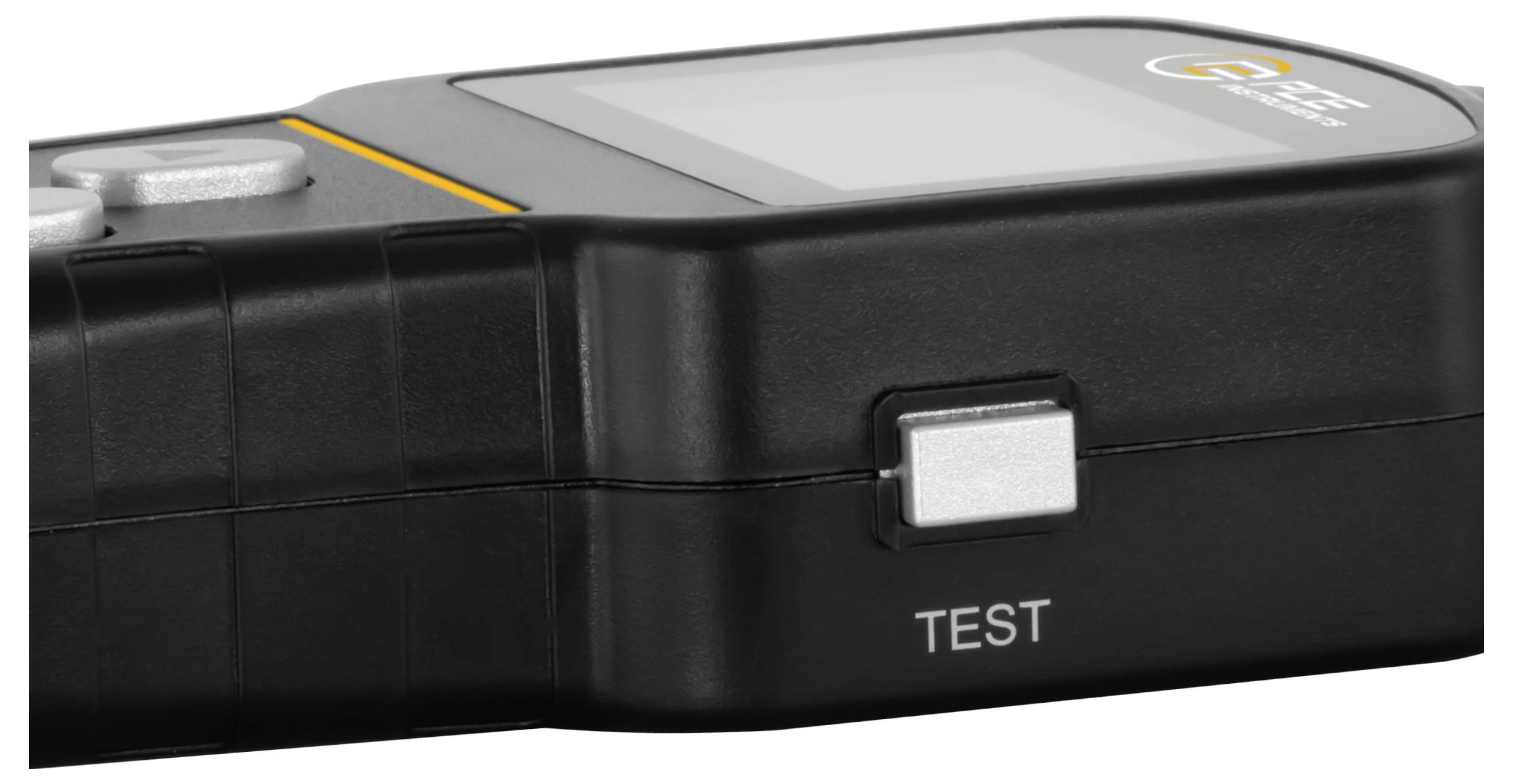 Černé přenosné testovací zařízení se stříbrným tlačítkem označeným "TEST" a malým displejem na vrchu.