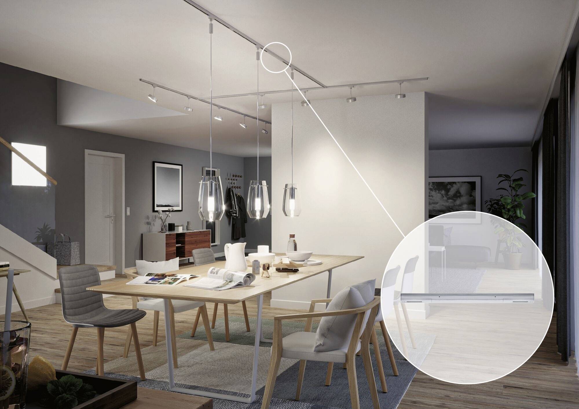 Moderní jídelna s dřevěným jídelním stolem a židlemi, betonovými stěnami a minimalistickým designem. Závěsná svítidla osvětlují stůl.
