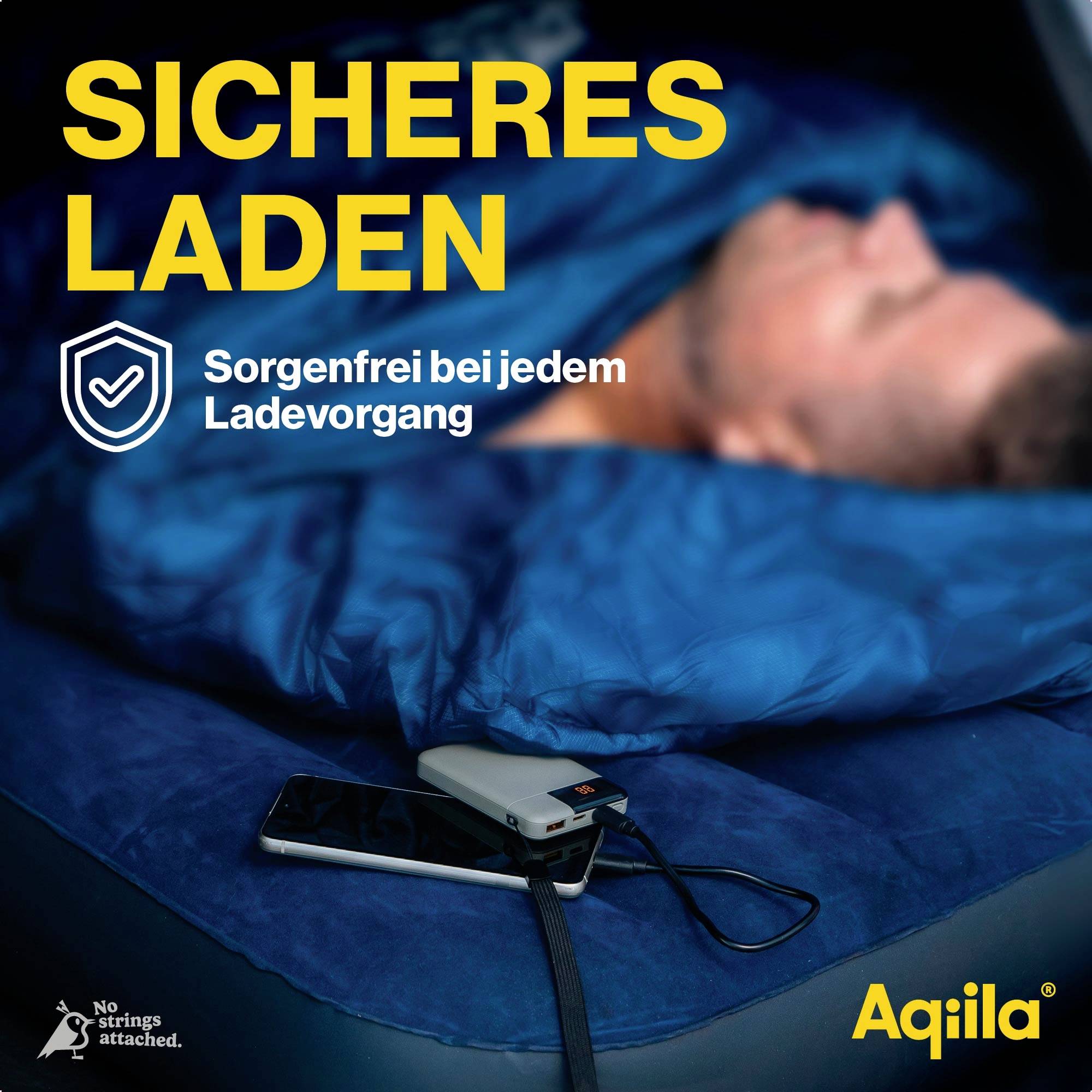 "Bezpečné nabíjení. Bez starostí při každém nabíjení." Spící člověk vedle chytrého telefonu nabíjejícího se na posteli.