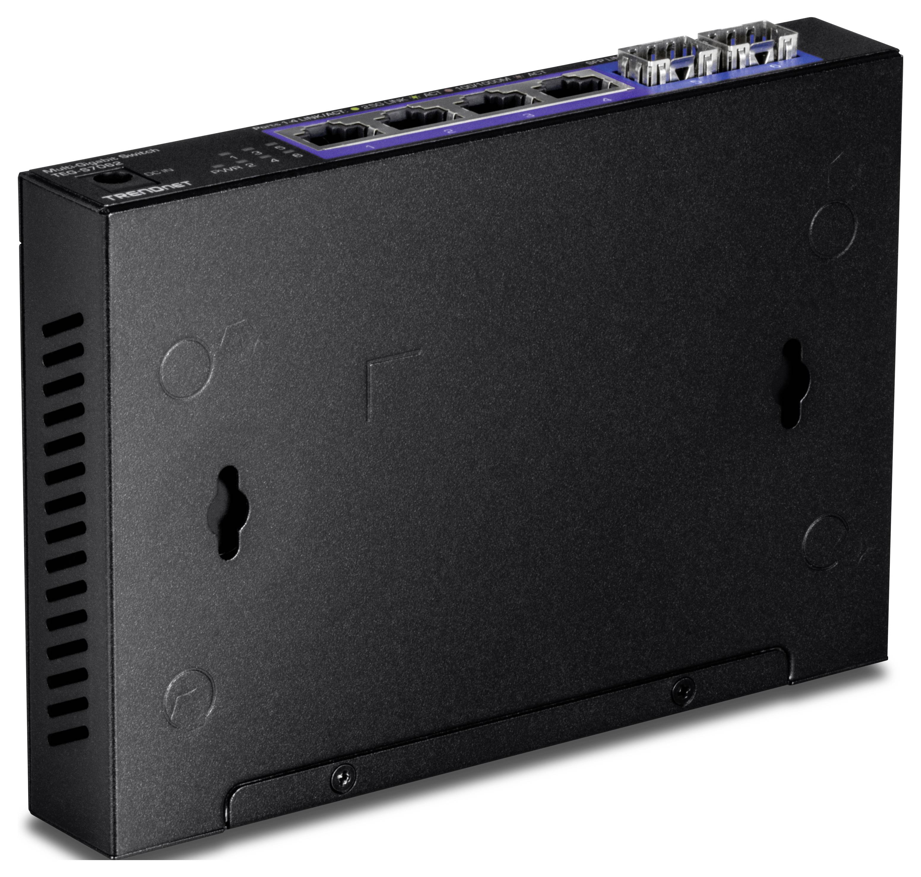 Nahoře je zobrazen černý síťový switch s několika ethernetovými porty. Zařízení je vhodné pro montáž na zeď.