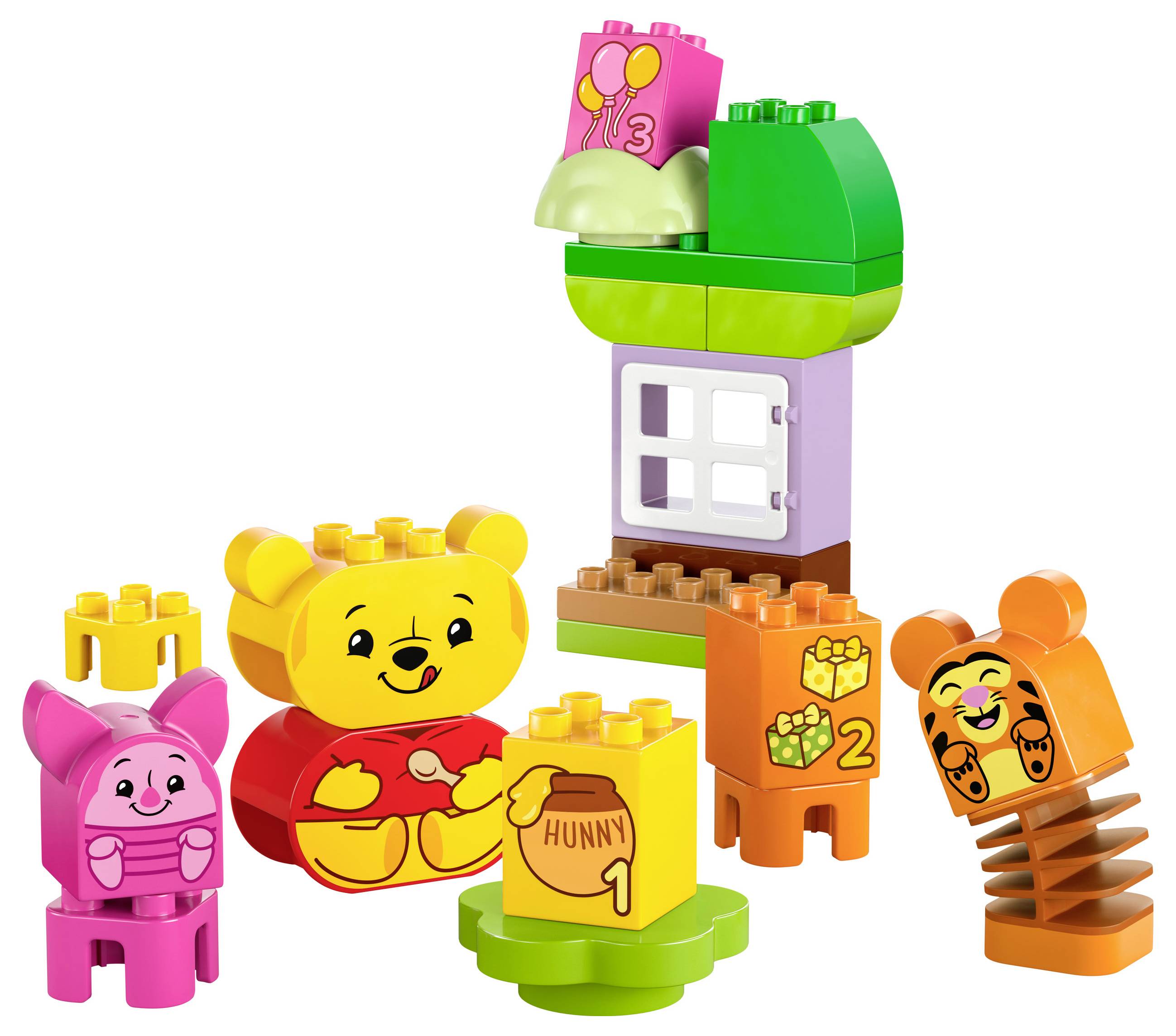Sada Lego stavebnice s barevnými kostkami zobrazuje postavu, která jí med, obklopená veselými zvířecími figurkami a malým domkem.