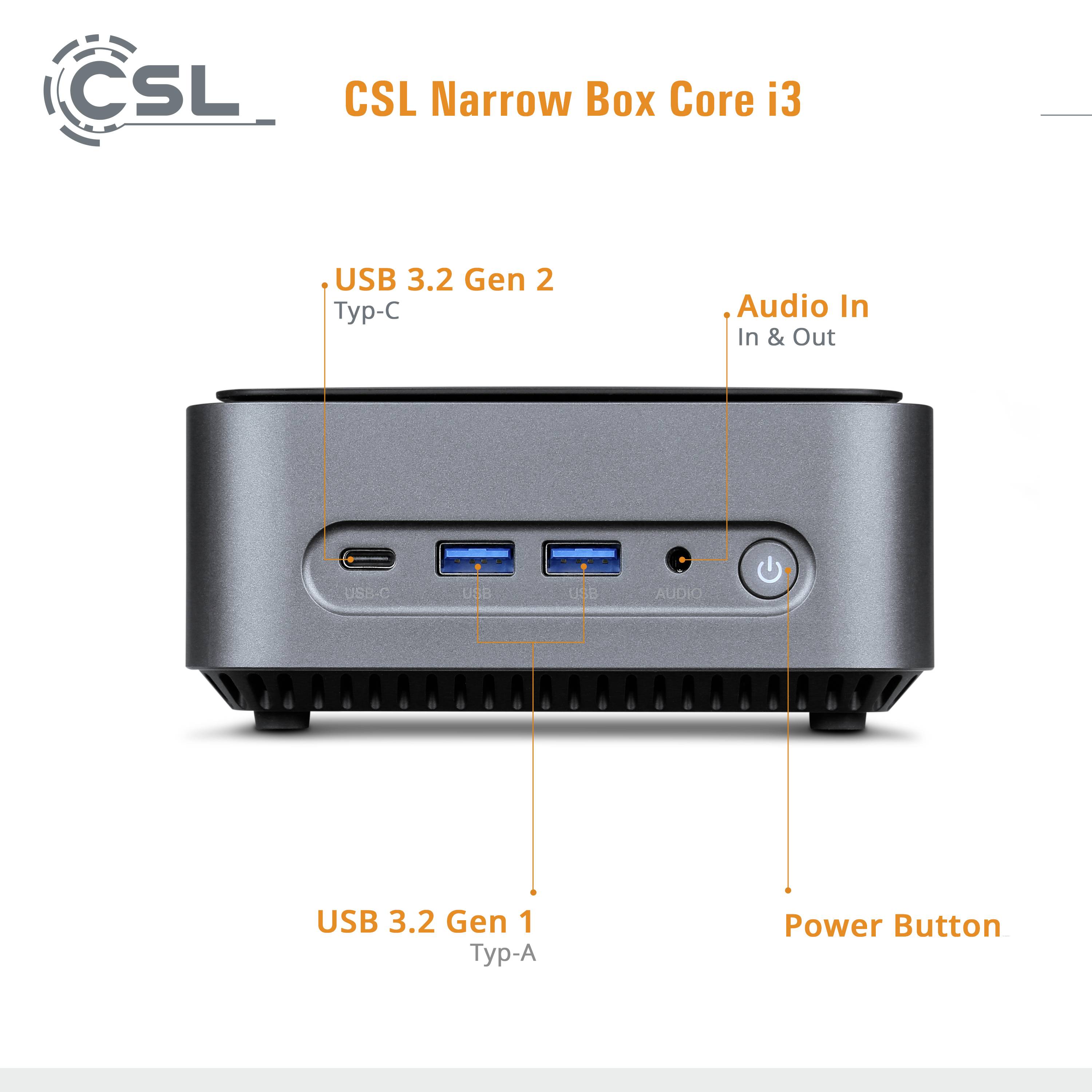 Pohled zepředu na malou šedou počítačovou skříň s konektory: USB-C, dva USB-A, audio vstup a výstup. Štítek zobrazuje 'CSL Narrow Box Core i3'.