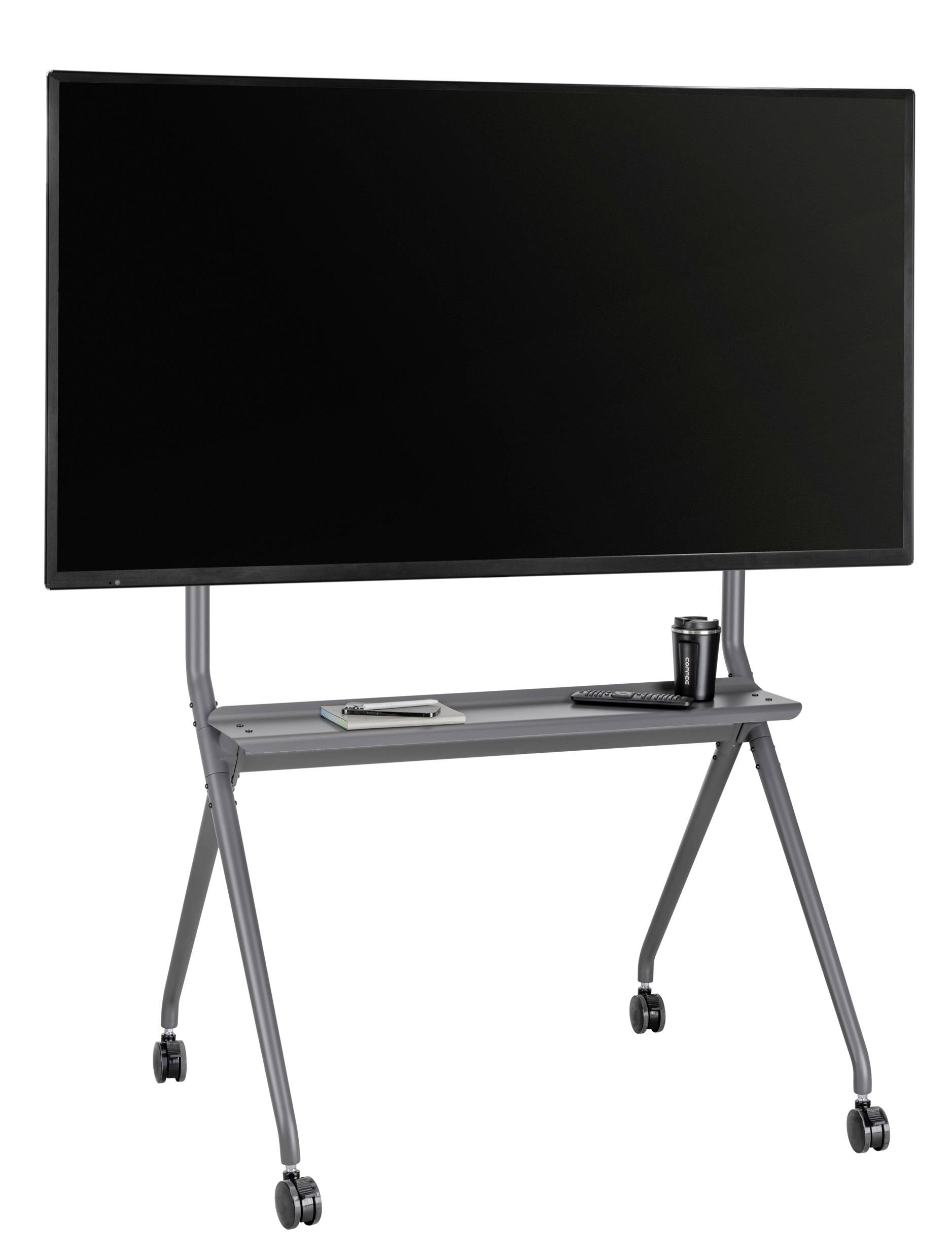 Velký černý monitor na pojízdném stojanu, pod ním přihrádka s poznámkovým blokem, perem a šálkem kávy.