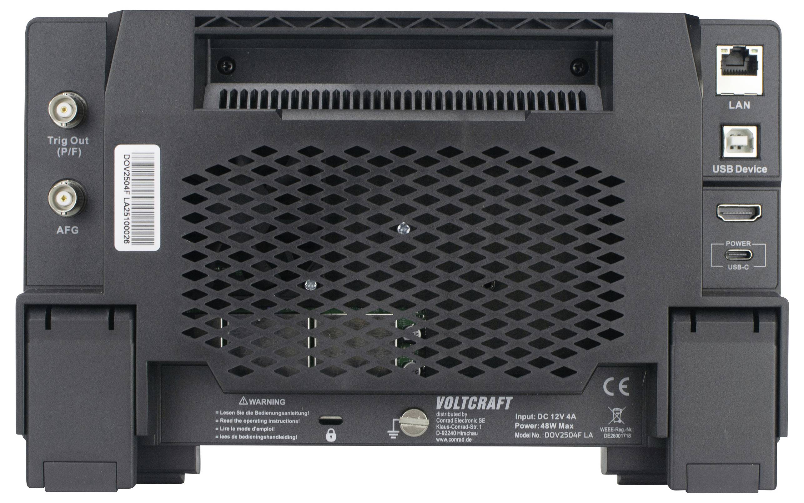 Pohled zezadu na zařízení Voltcraft se vstupními porty pro LAN, USB a HDMI. Jsou viditelné větrací mřížky a výstražné štítky.