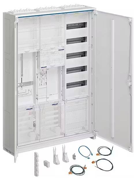 Velká otevřená rozvodná skříň s několika prázdnými přihrádkami a výplněmi. Na podlaze leží kabely a příslušenství.