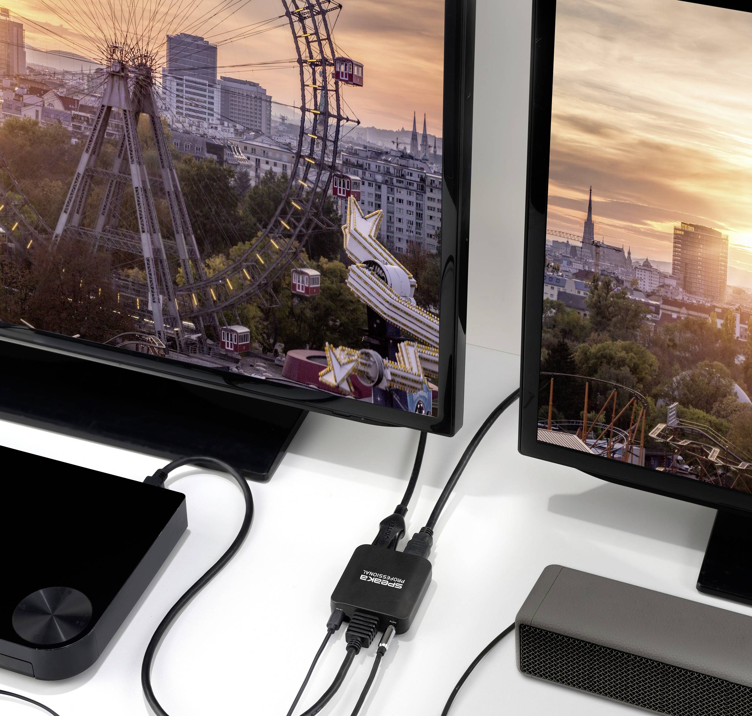 Obří kolo a panorama města jsou zobrazeny na dvou monitorech propojených HDMI kabelem s adaptérem uprostřed.