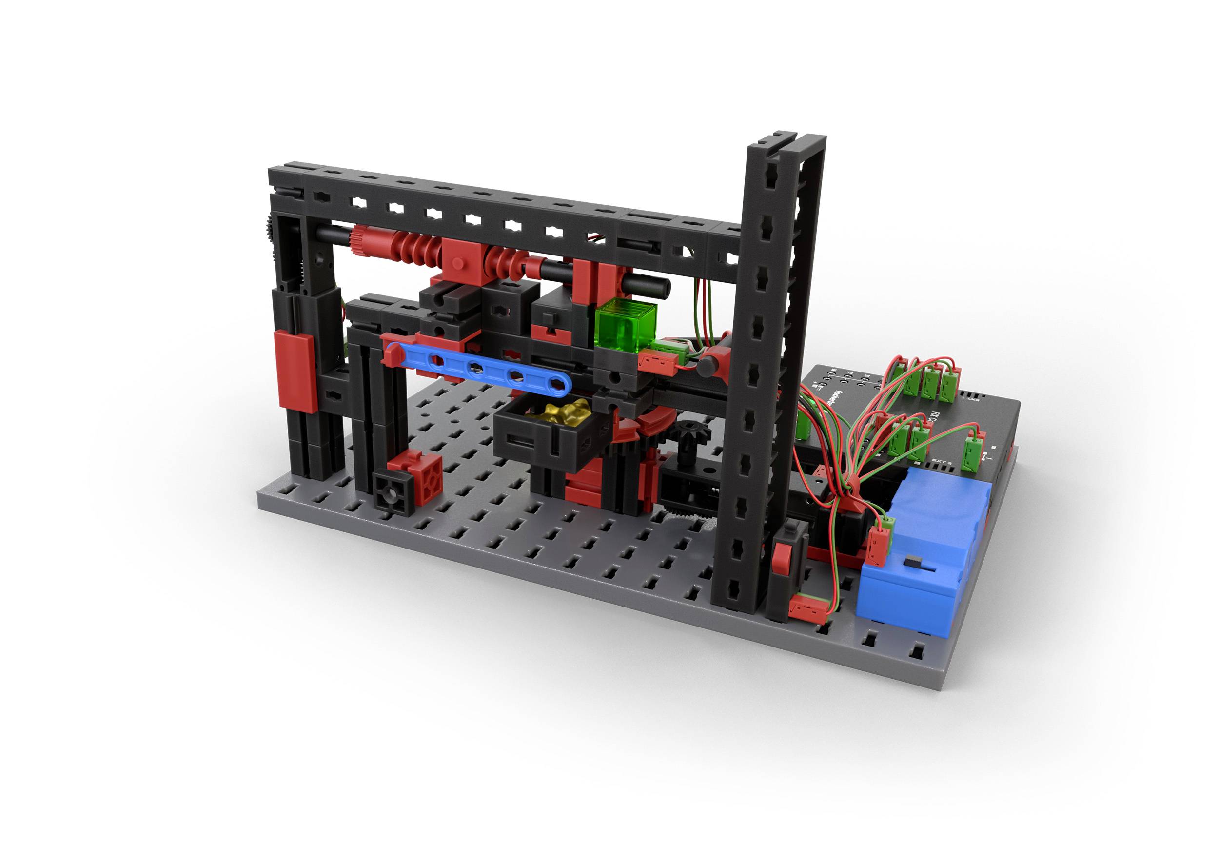 Model stavebnice stroje s barevnými kostkami a kabely na šedé základní desce, znázorňující mechanickou konstrukci.