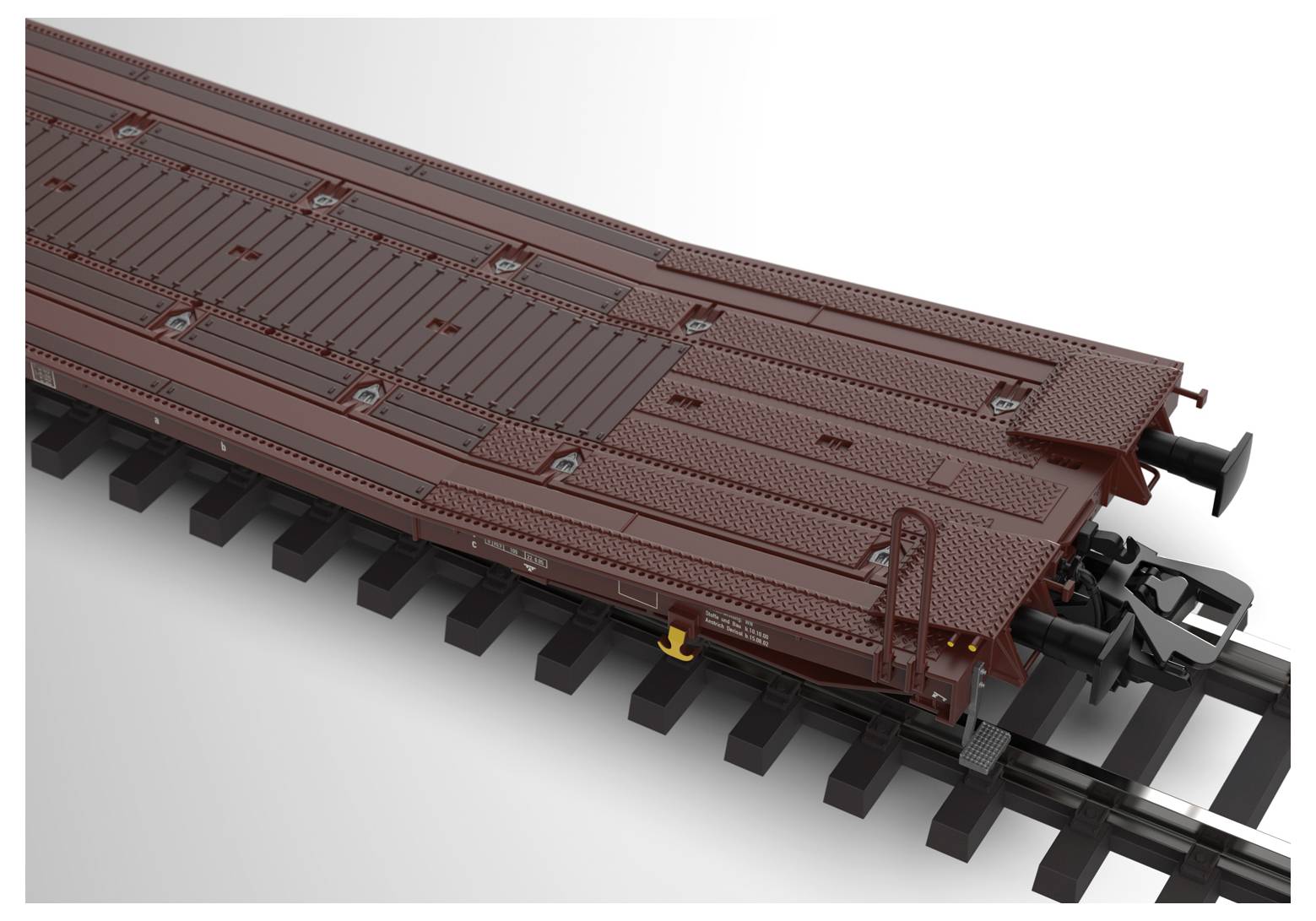 Hnědý model nákladního vagónu na kolejích, s detailní strukturou povrchu, bez viditelného pozadí.