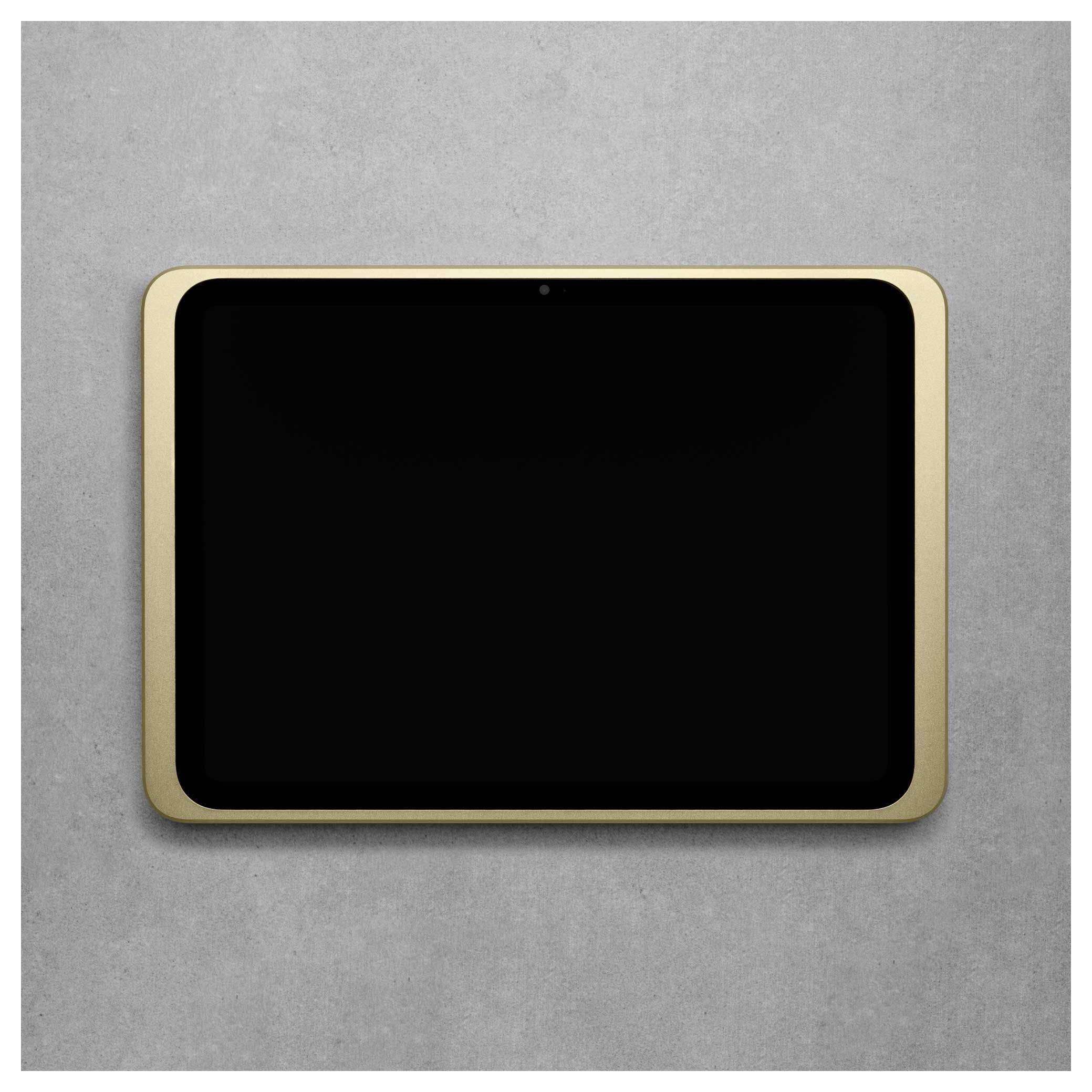 Moderní tablet se zlatým rámečkem na šedém pozadí. Displej je černý a vypnutý.