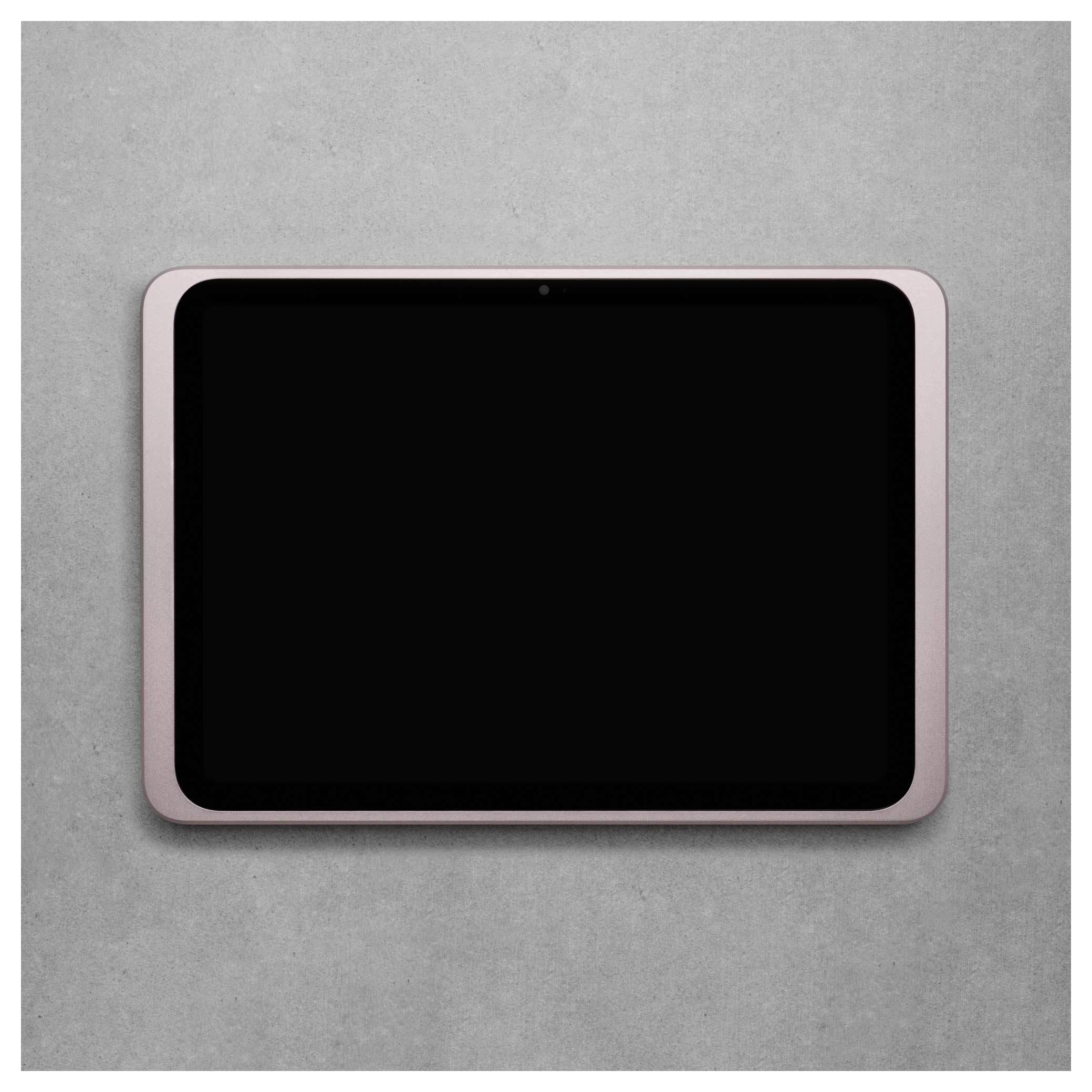 Růžový tablet s černou obrazovkou na šedém pozadí. Zařízení je vypnuté a nachází se v centru obrazu.