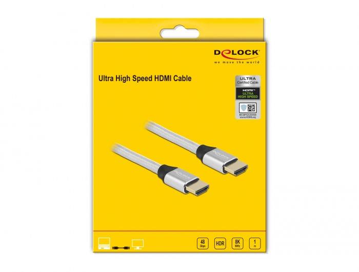 Obal kabelu 'Delock' Ultra High Speed HDMI, žluté barvy. Dva kabely se stříbrnými konektory jsou viditelné. Podporuje 8K, HDR, HDCP.
