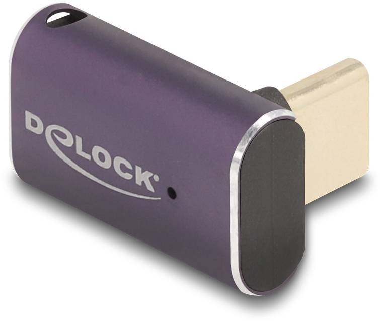 Fialový USB-C adaptér od společnosti Delock s oválným tvarem a popiskem na straně, zobrazený v šikmém pohledu.
