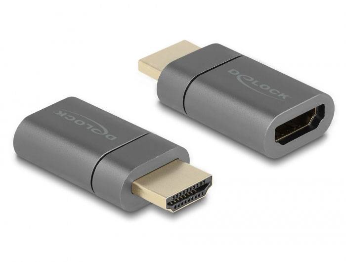 'Dva malé adaptéry s HDMI konektorem, tmavě šedé, jeden konektor samčí a druhý samičí, ležící vedle sebe.'