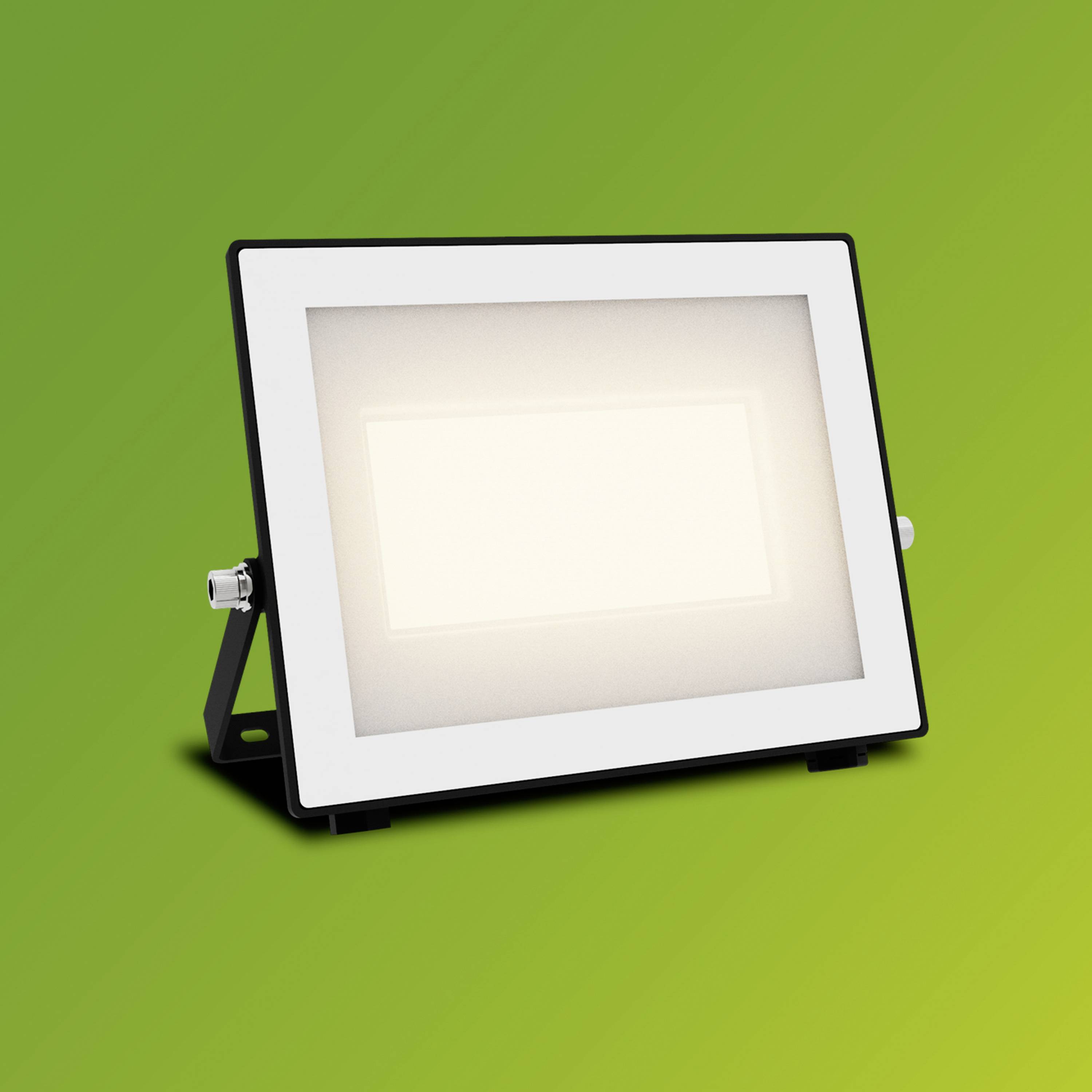 Obdélníkový LED reflektor svítí jasně na zeleno-žlutém pozadí.