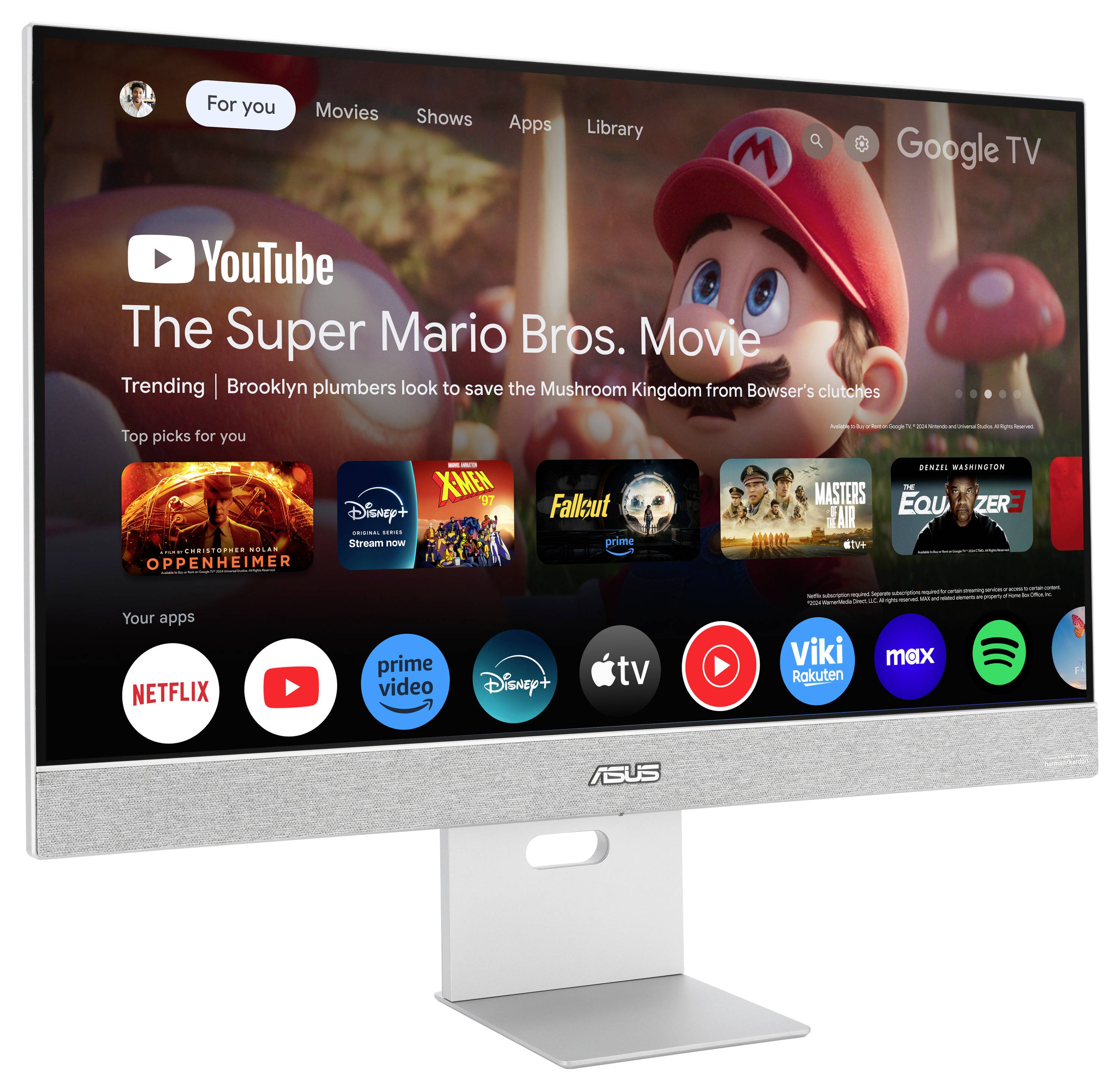 Monitor zobrazuje Google TV s filmem 'Super Mario Bros. ve filmu'. Pod ním jsou různé streamovací aplikace jako Netflix, Prime Video a Disney+.