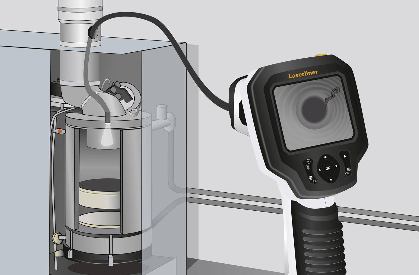 Ruční zařízení s displejem zkoumá průběh potrubí uvnitř stroje.