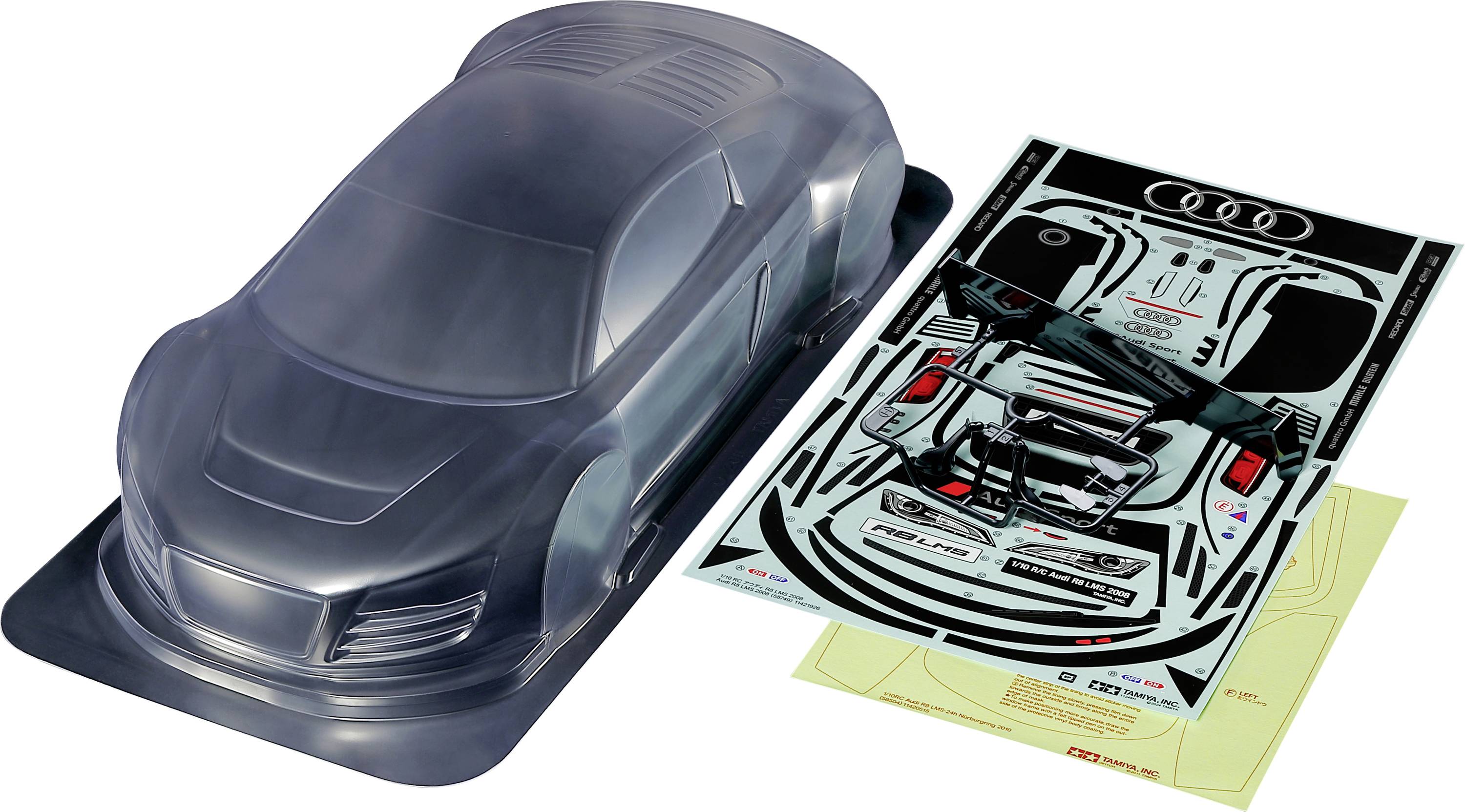 Průhledná sada modelového auta s nálepkami designu Audi vedle ní. Obsahuje nelakovanou karoserii a detailní arch samolepek.