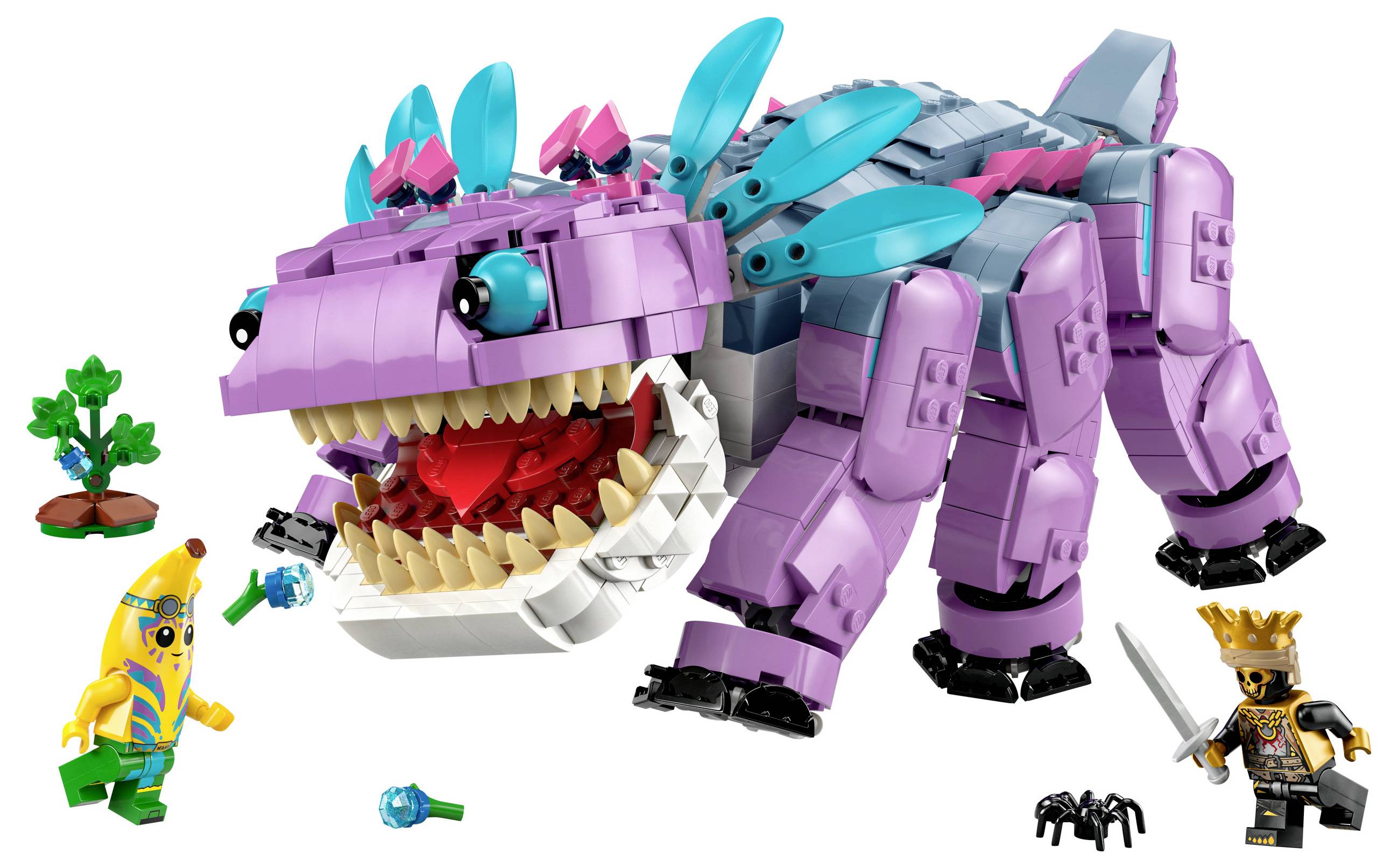 Barevný lego krokodýl s otevřenou tlamou je obklopen dvěma lego figurkami. Jedna z nich má na sobě banánový kostým.