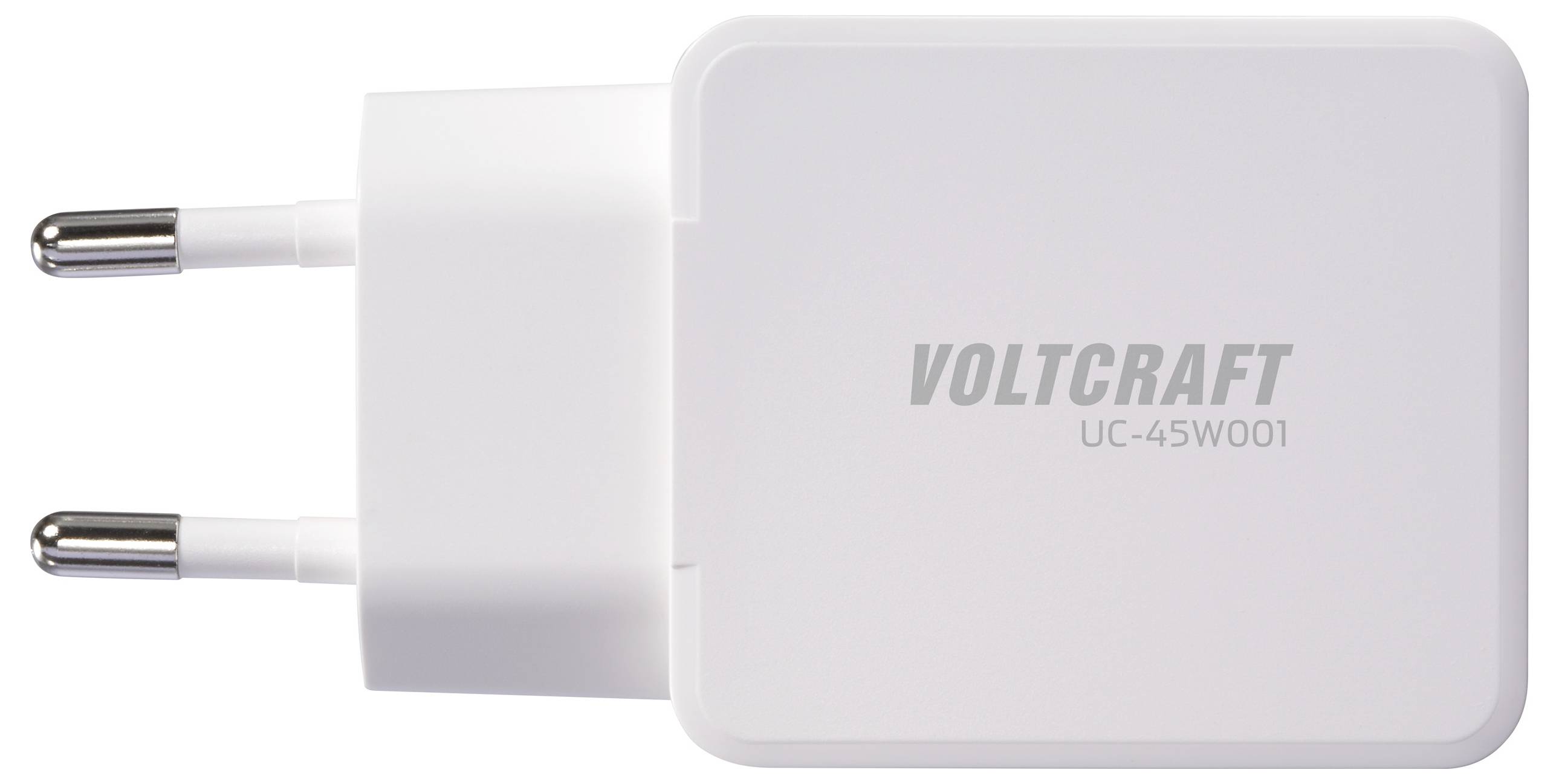 Bílý napájecí adaptér Voltcraft UC-45W001 se dvěma kovovými kolíky, používaný pro nabíjení elektronických zařízení, zobrazený na jednoduchém pozadí.