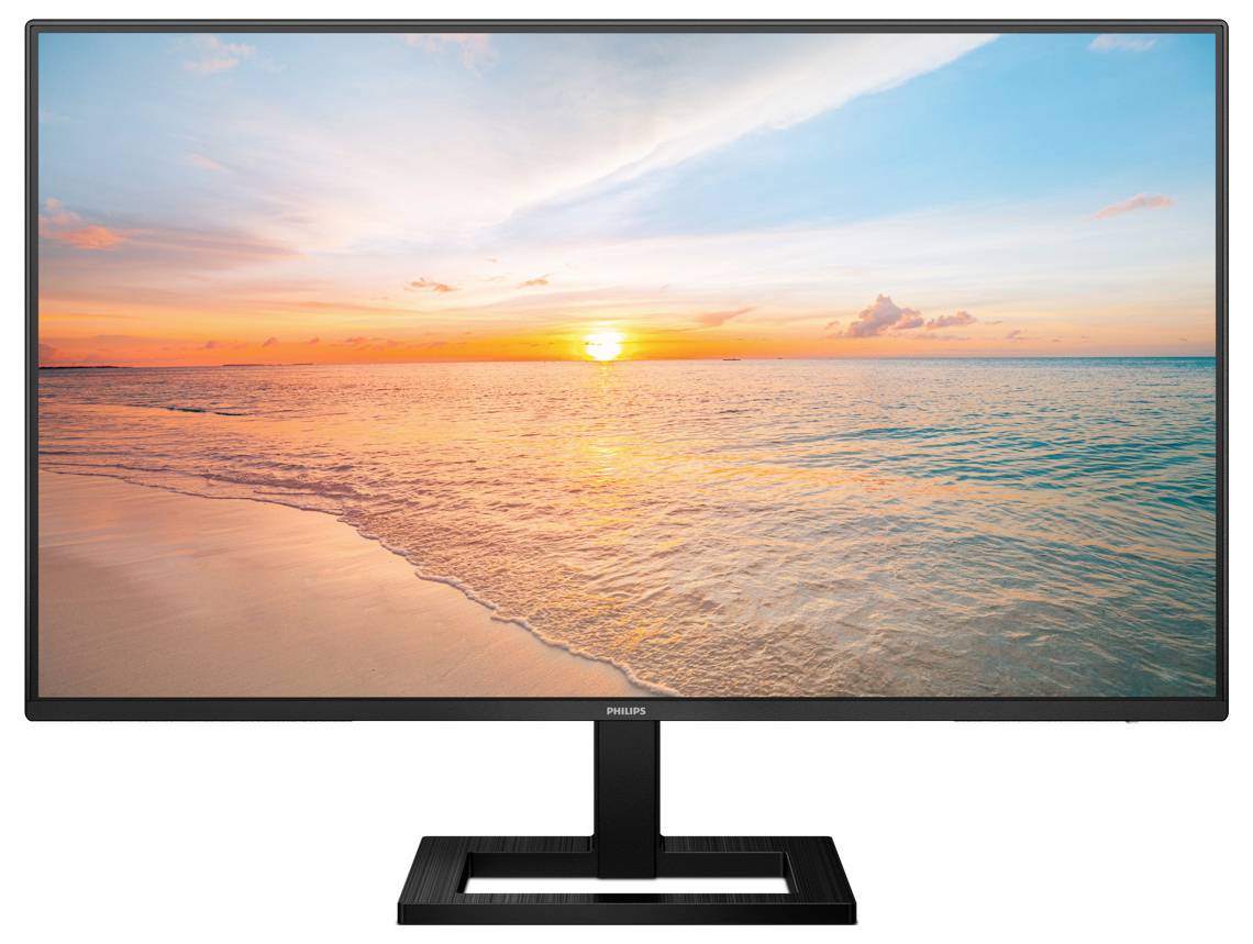 Monitor zobrazuje obraz západu slunce nad klidnou pláží s bezmračnou oblohou a navozuje uvolněnou atmosféru.