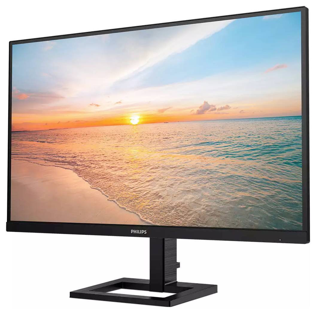 Monitor zobrazuje krajinu se západem slunce nad mořem. Obloha je částečně zatažená a voda klidná.