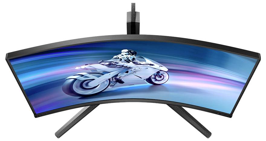 Zakřivený monitor z pohledu shora, zobrazující futuristický motocykl na obrazovce, s dynamickými modrými světelnými efekty v pozadí.