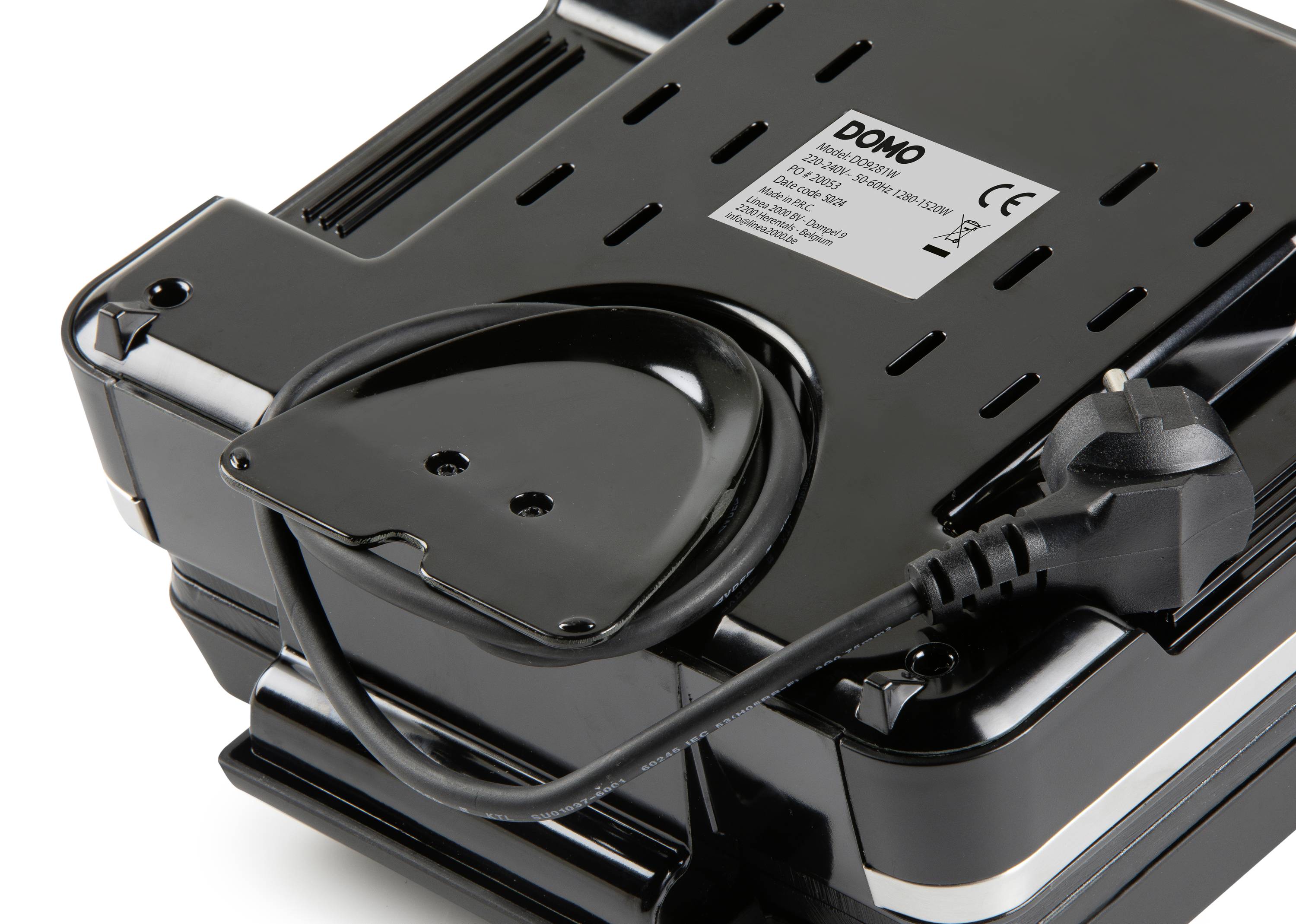 Černý kuchyňský spotřebič s napájecím kabelem na spodní straně. Je viditelná štítku výrobce, který ukazuje informace o modelu a bezpečnosti.