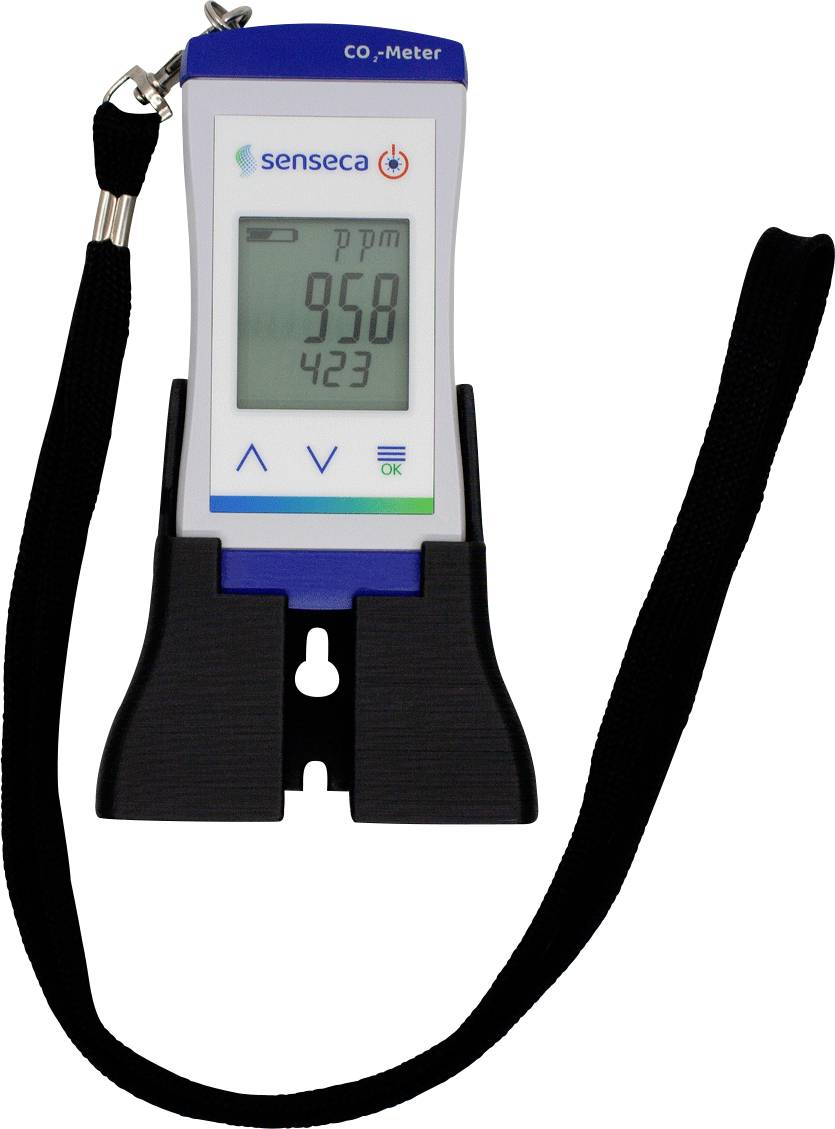 Přenosný měřič CO₂ s displejem ukazuje '958 ppm'. Má ovládací tlačítka a černý pásek pro nošení.
