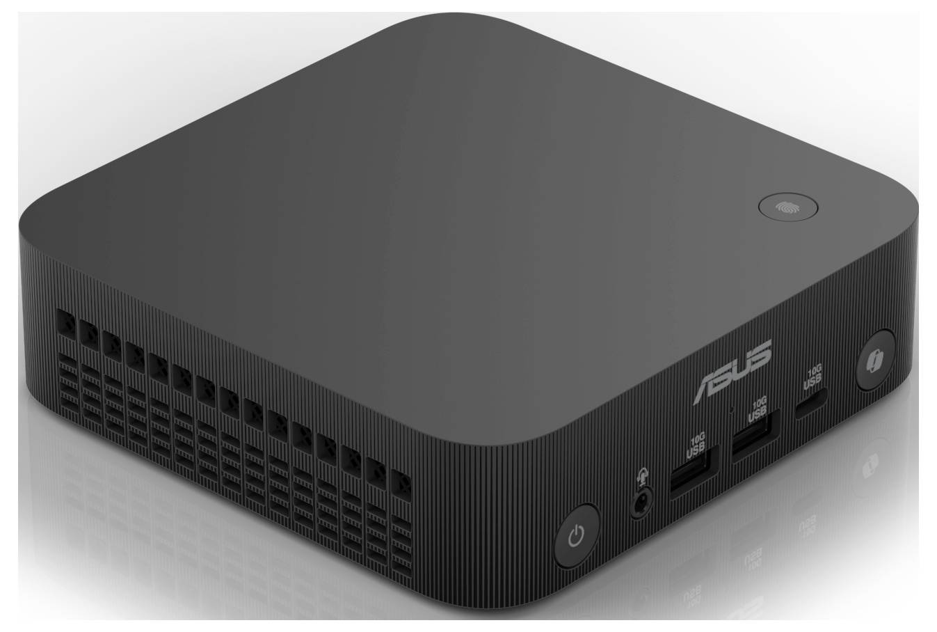 Černý minipočítač s logem ASUS na horní straně. Vpředu jsou viditelné čtyři USB porty a vypínač.