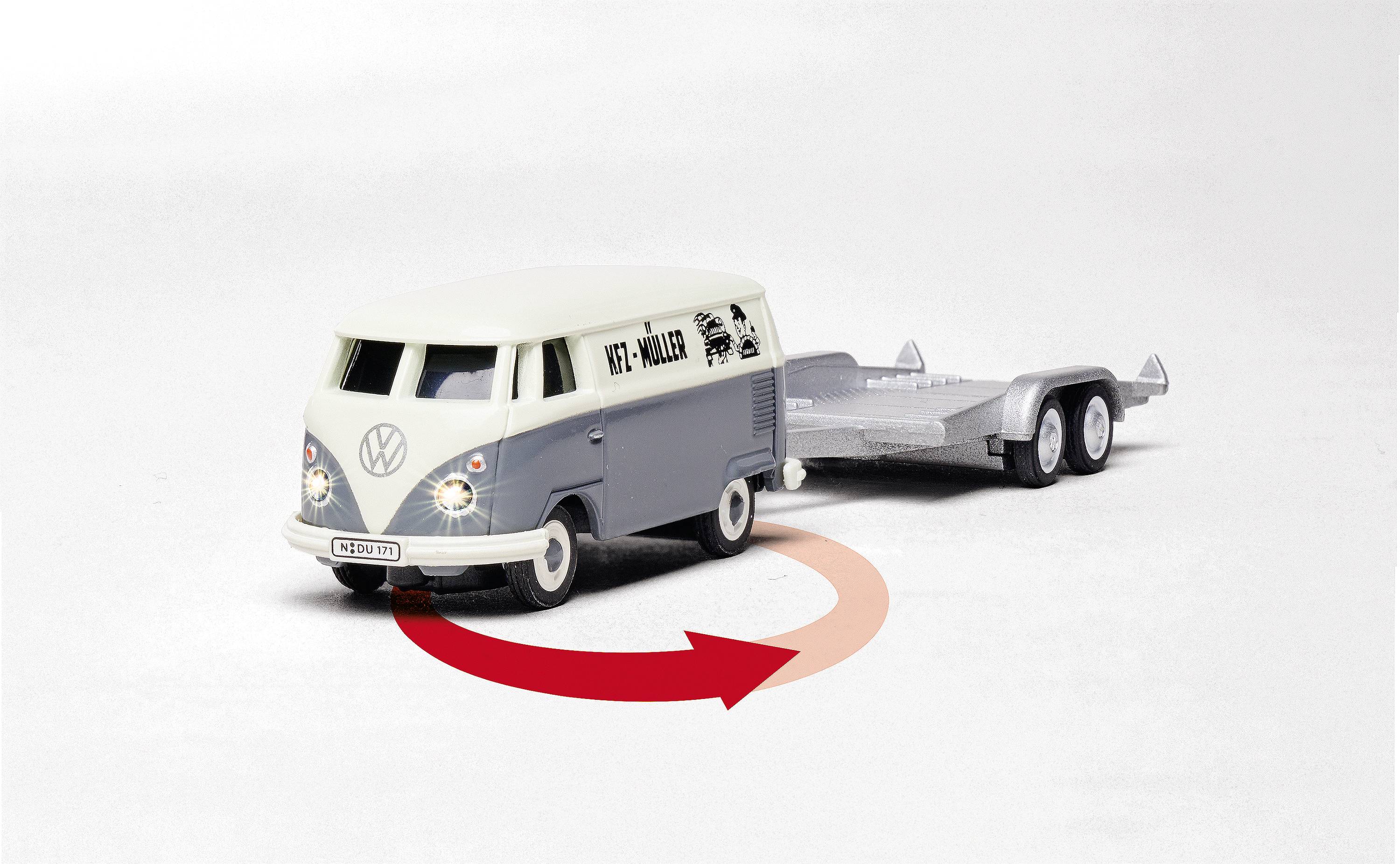 Model volkswagenu s přívěsem stojí šikmo doleva. Červený šipkový symbol naznačuje zatáčení doleva.